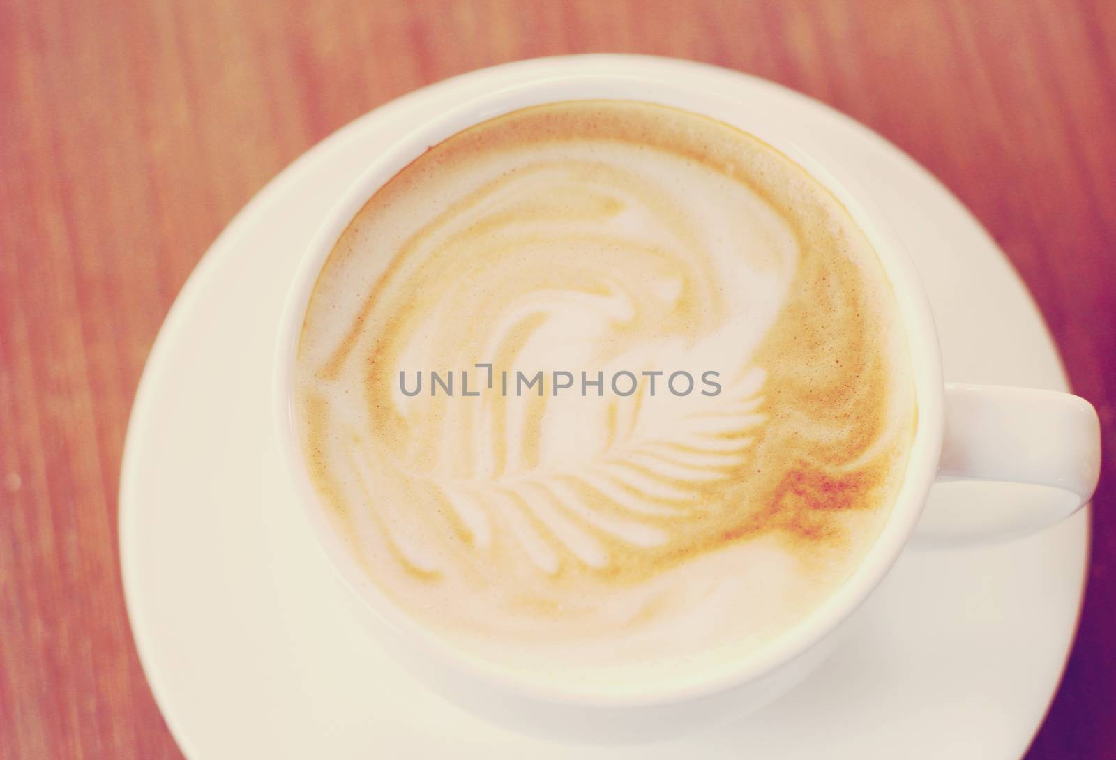 Cup of latte or cappuccino coffee with retro filter effect by nuchylee