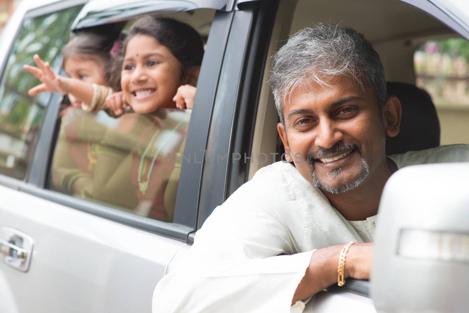 Indian family sitting in car ready to trip. Asian parent and children lifestyle.