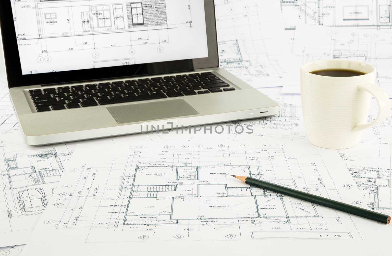 house blueprints and floor plan with laptop by vinnstock