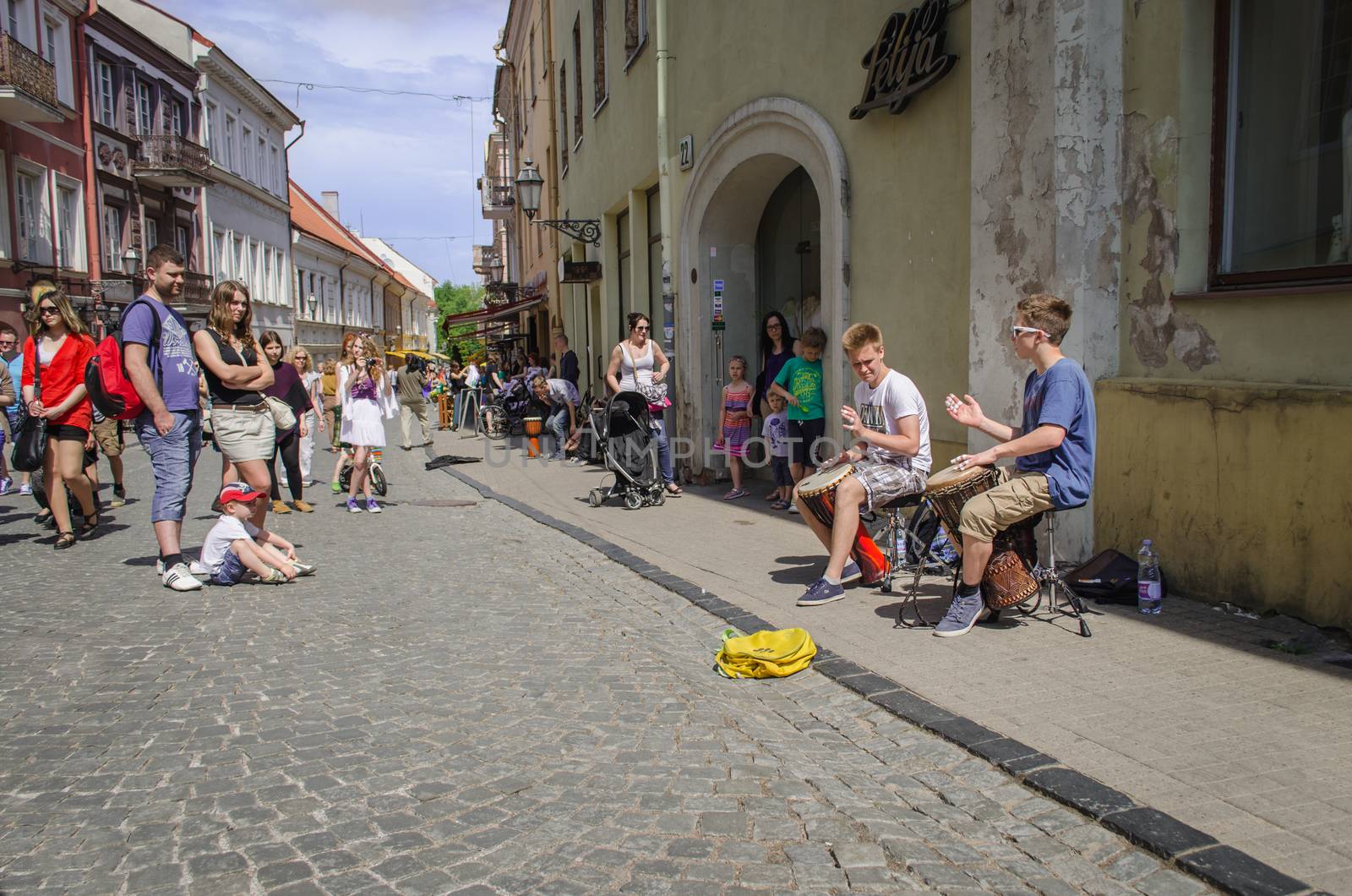 VILNIUS, LITHUANIA - MAY 18: boys with percussion on street musician festival and people flocks around on May 18, 2013 in Vilnius.