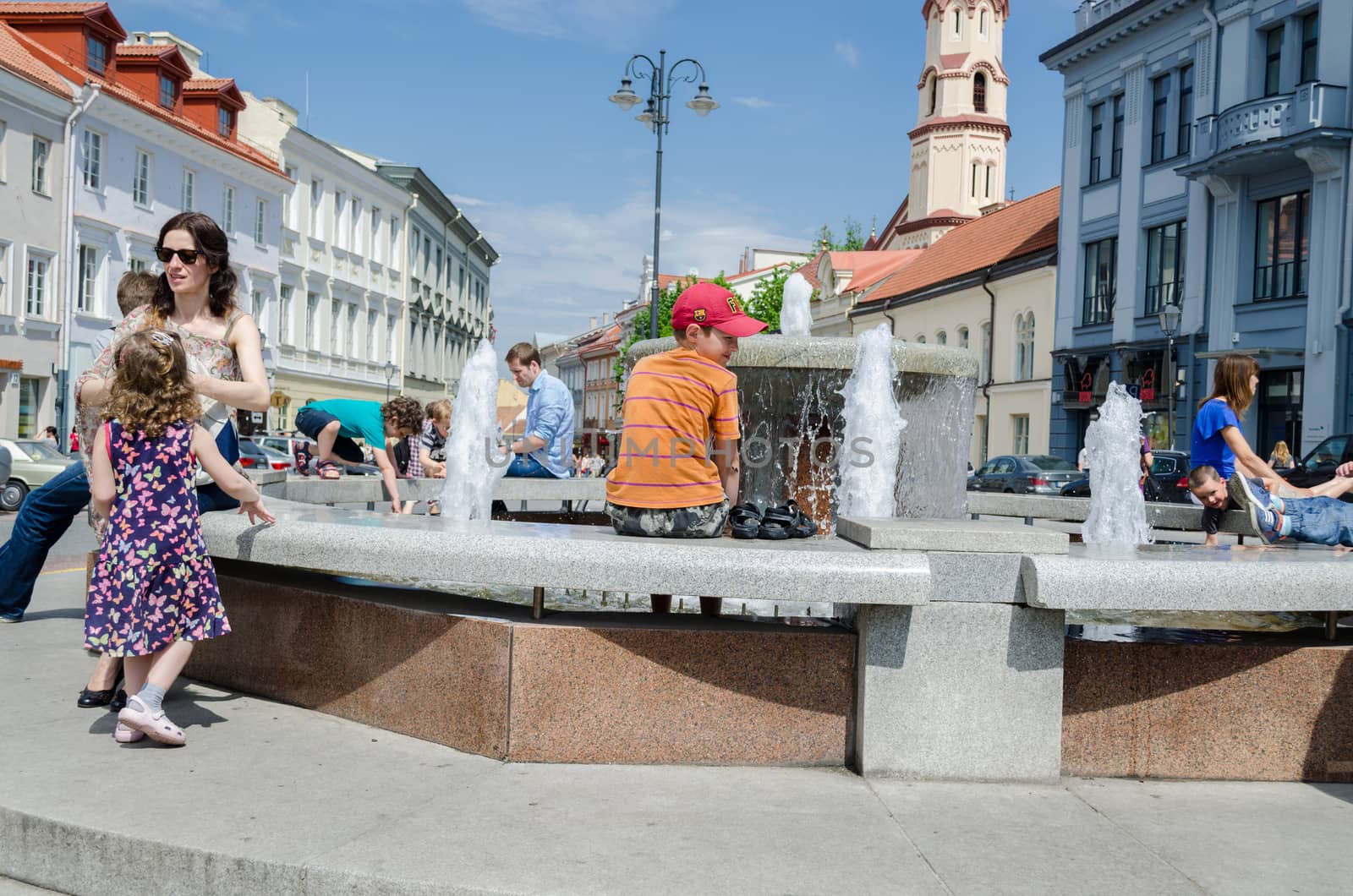 VILNIUS, LITHUANIA - MAY 18: children and mother leisure and recreation center of the fountain on hot spring day on May 18, 2013 in Vilnius.