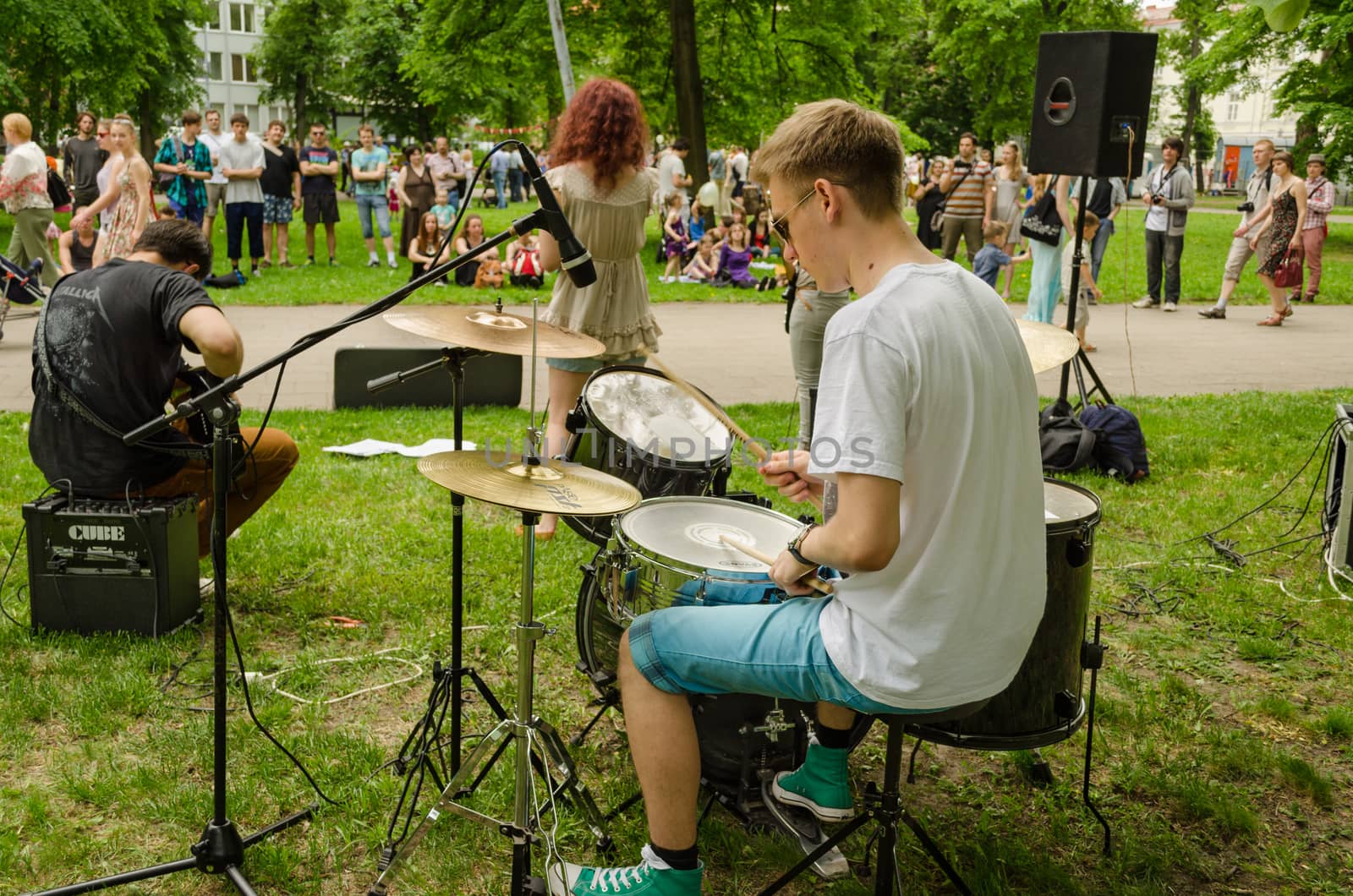 VILNIUS, LITHUANIA - MAY 18: the guy plays drums with friends music group for people in the park on May 18, 2013 in Vilnius.