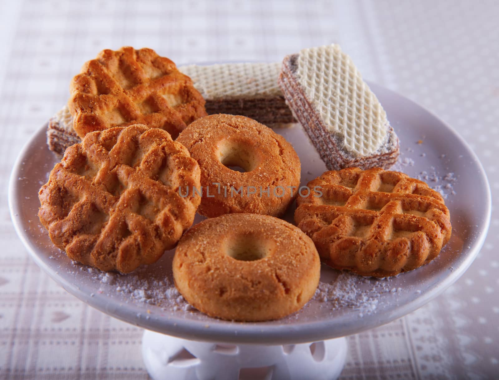 Biscuits of different kinds over a white ceramic stand