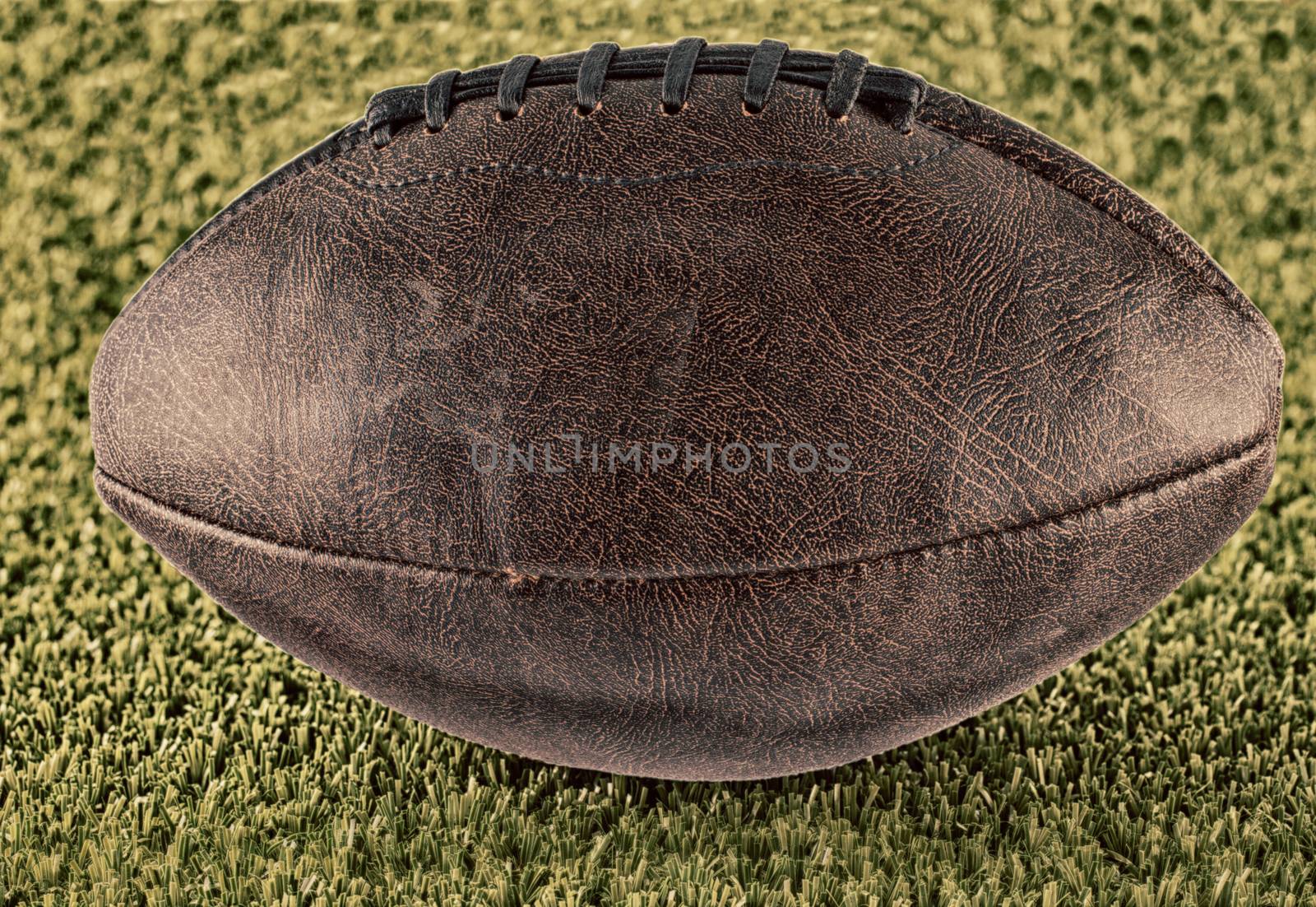 Leather football over a green grass field, hdr image