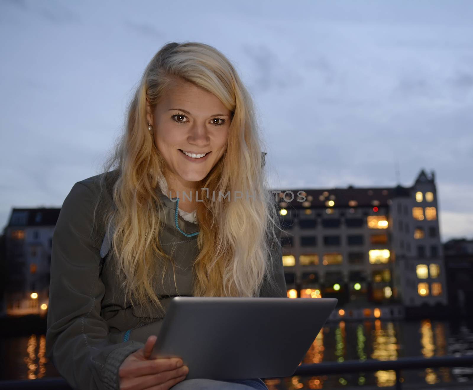 pretty young  woman with tablet computer in the city