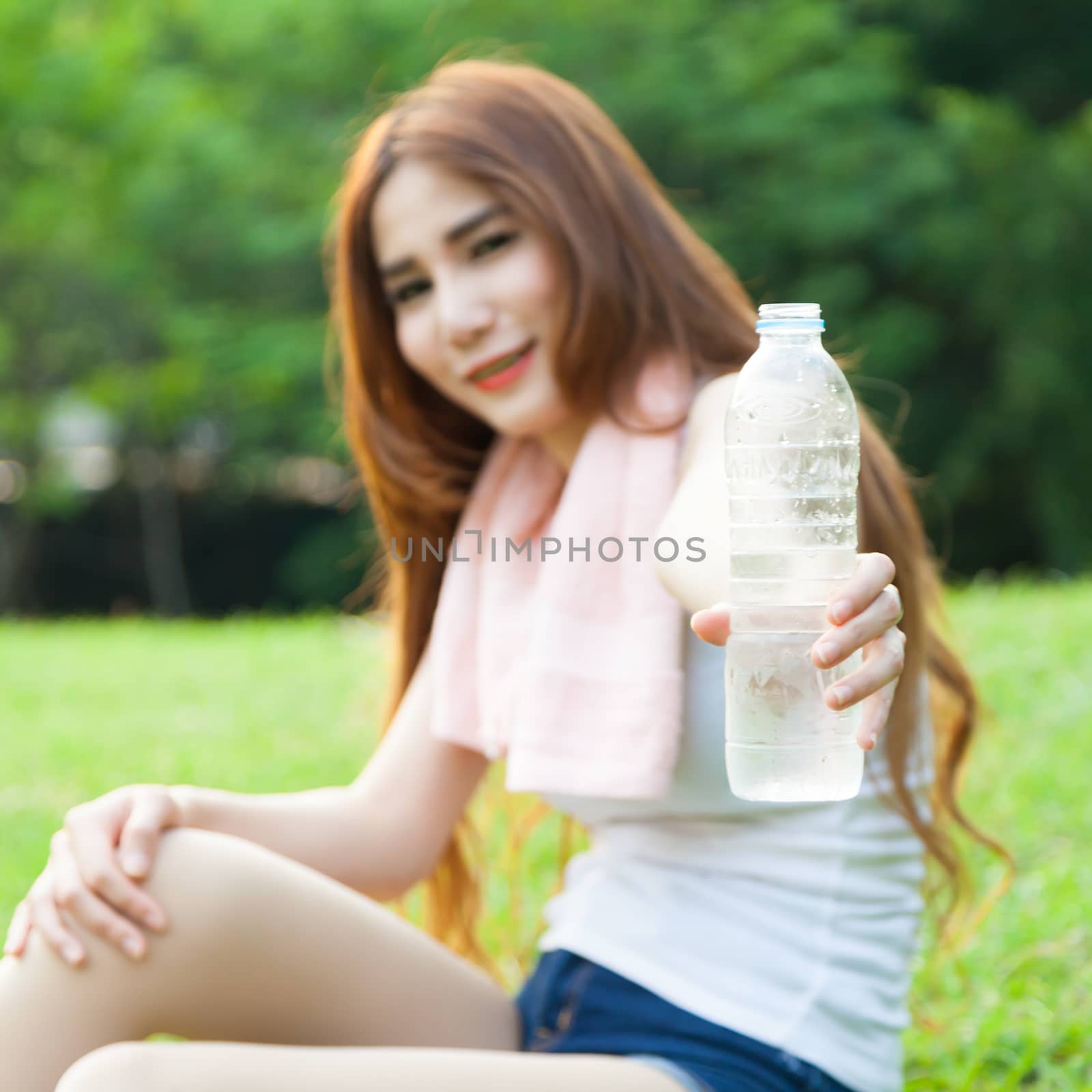 Women held a water bottle to drink. by a454