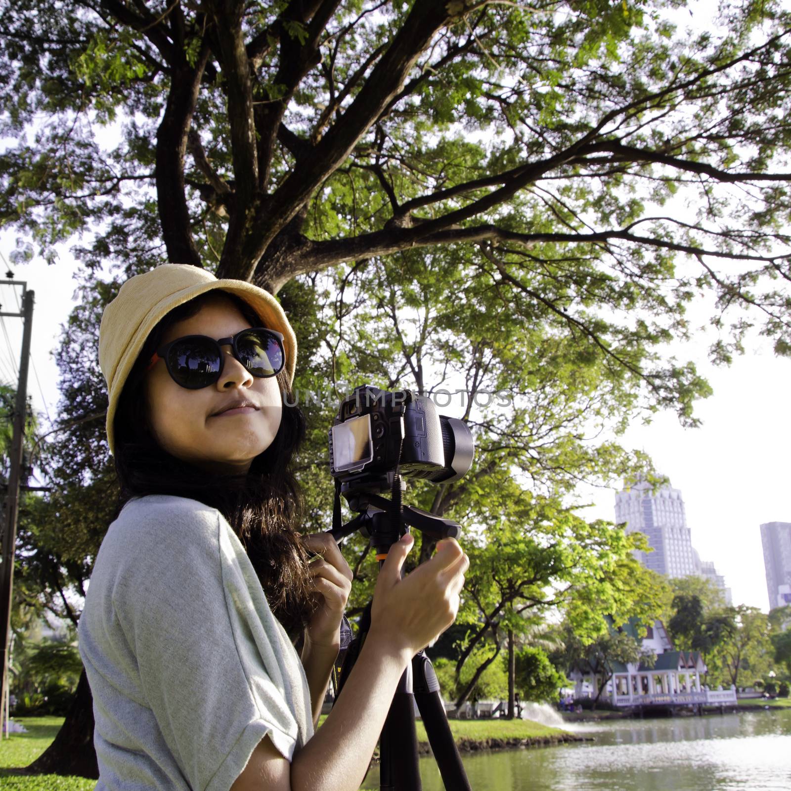 Asian girl with camera in public park
