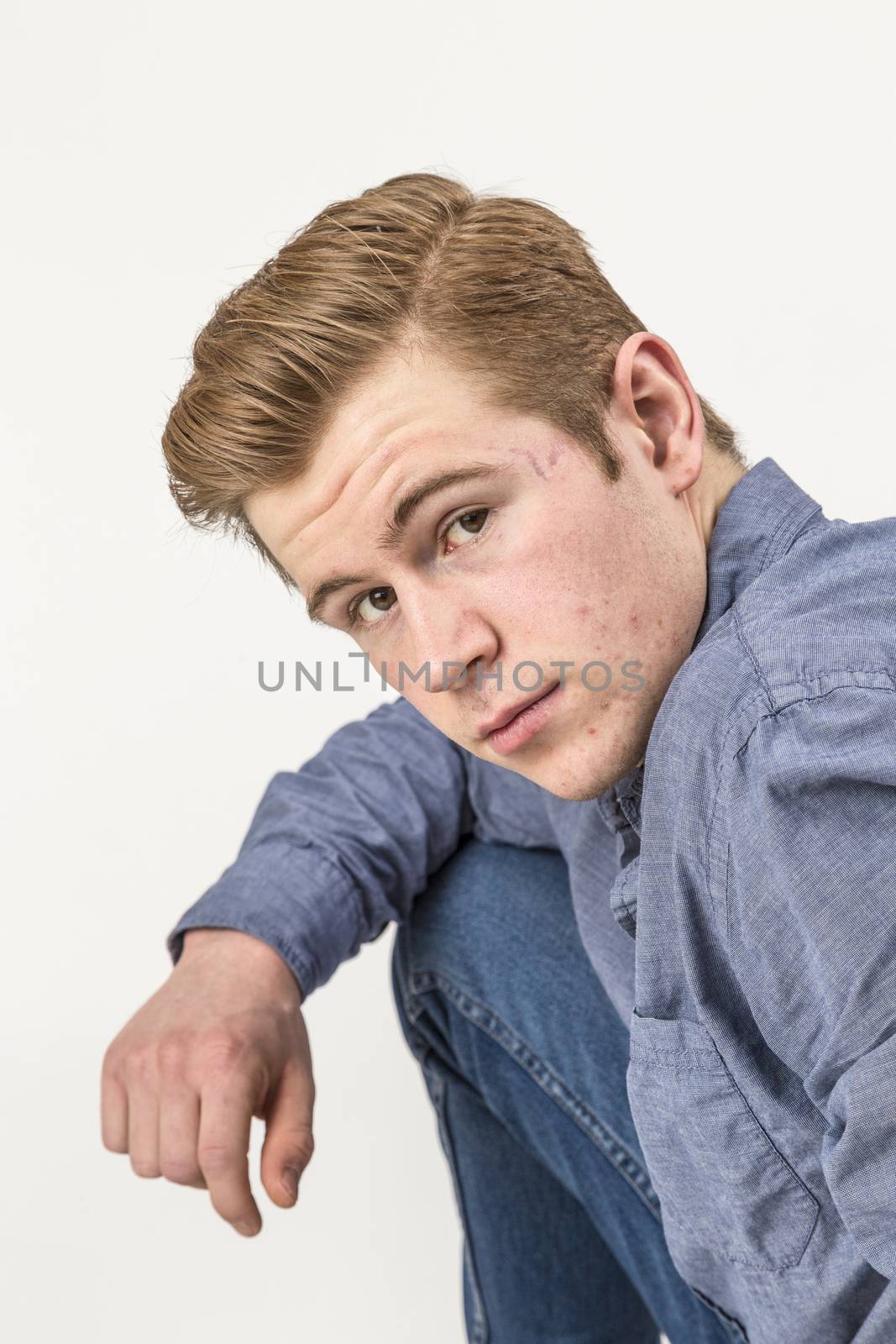 portrait of cool boy with red hair posing in studio