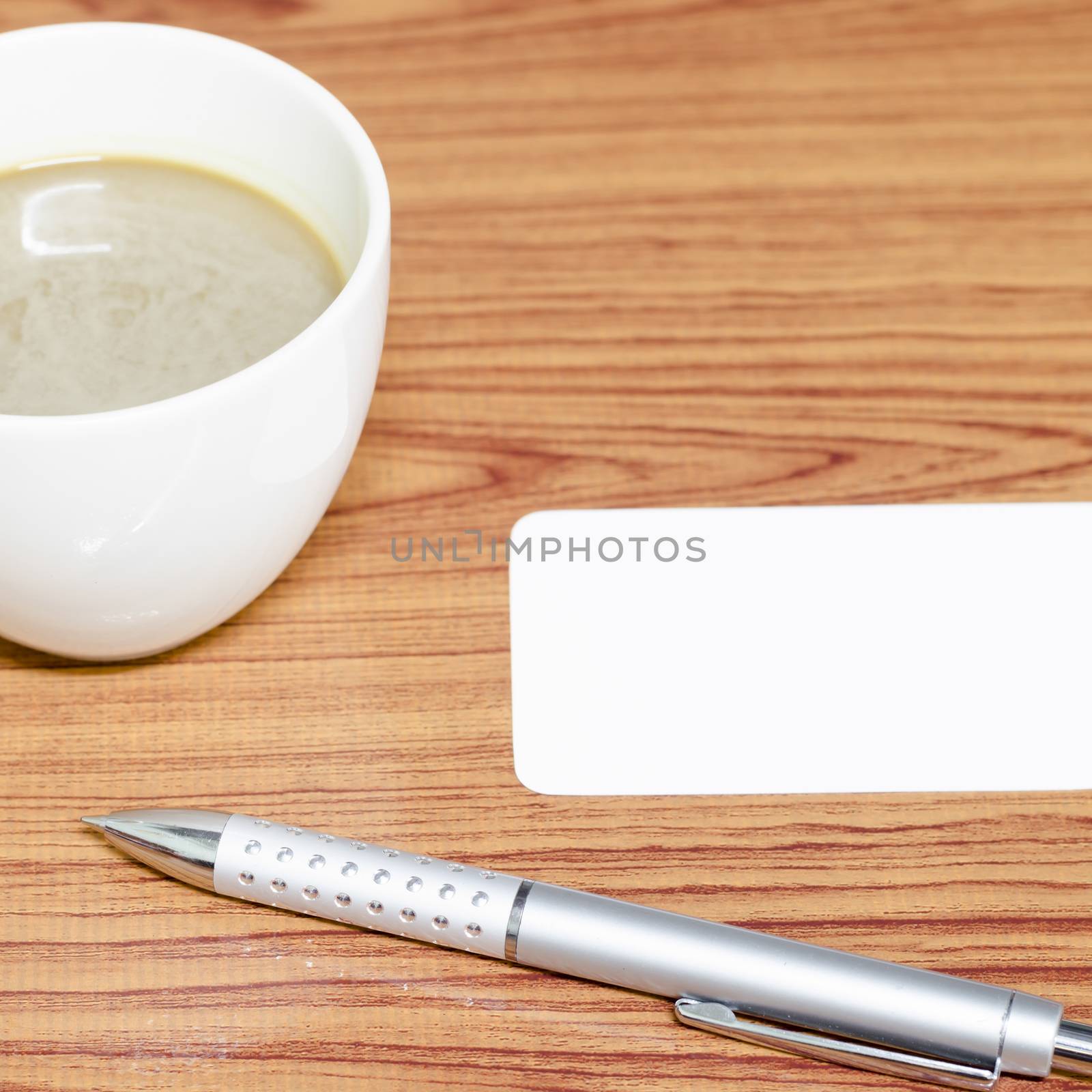 coffee cup and business card on wood background