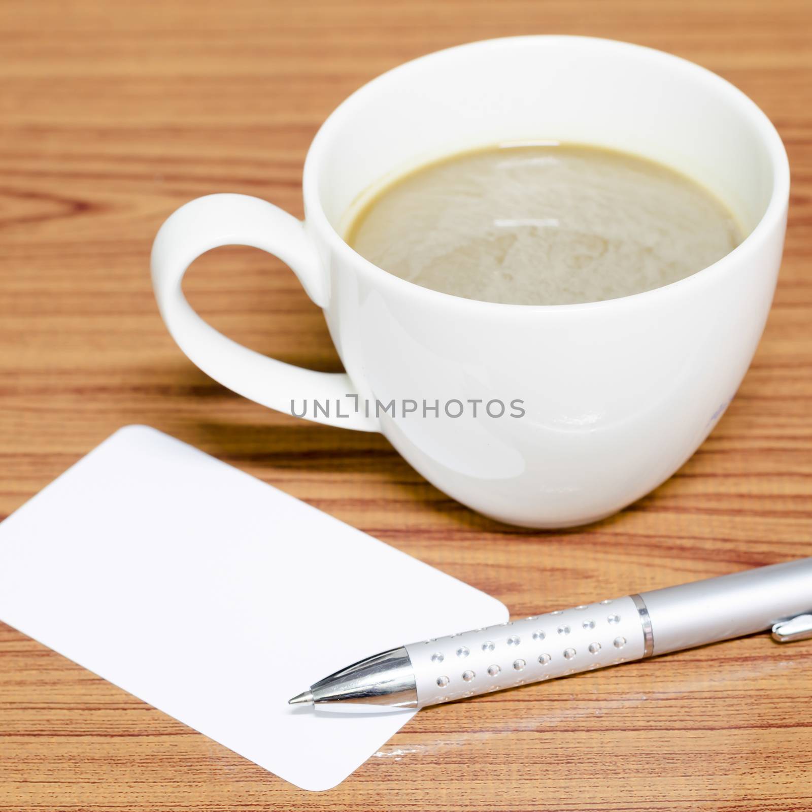 coffee cup and business card on wood background