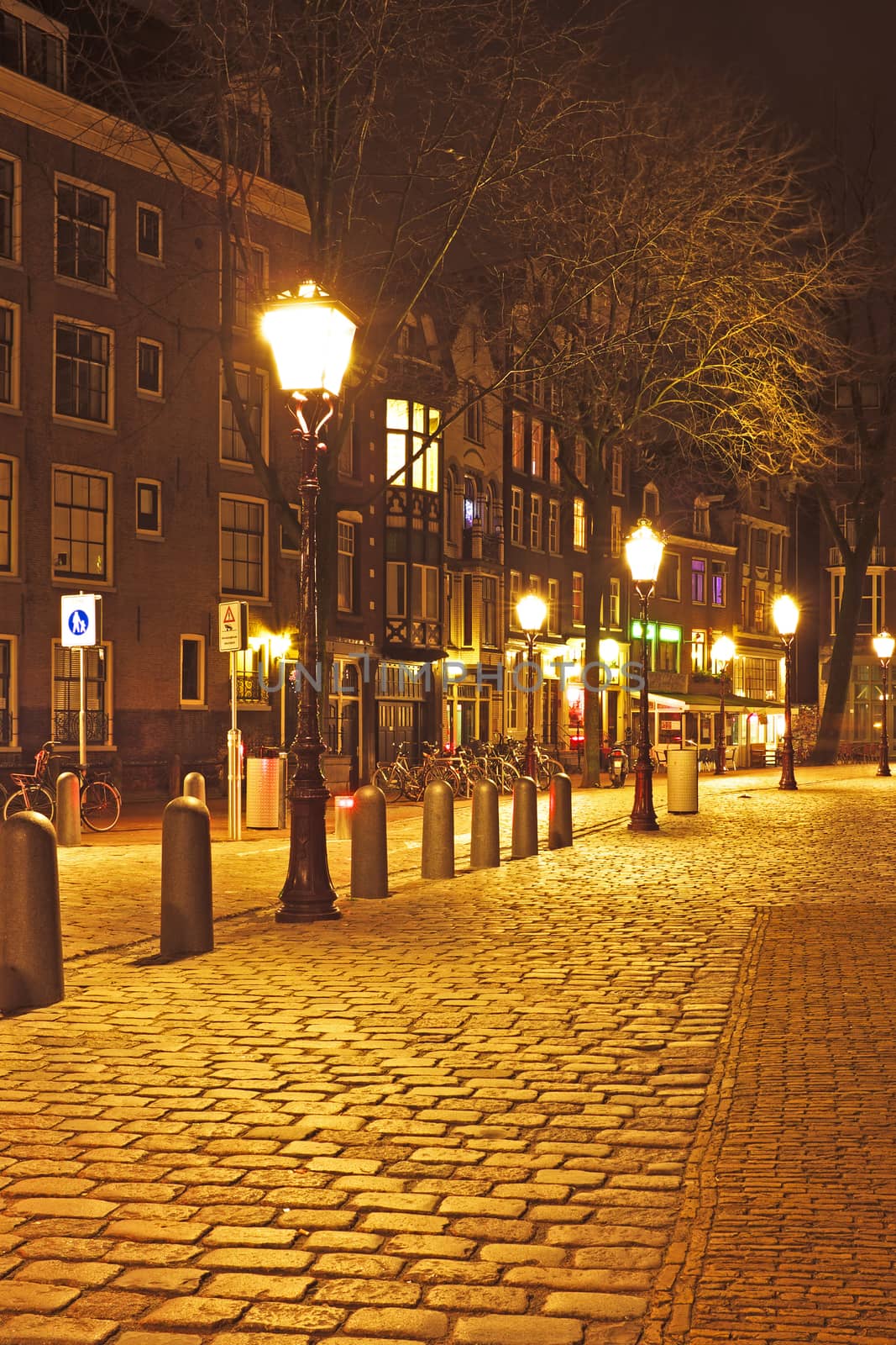 Medieval street in Amsterdam the Netherlands by night