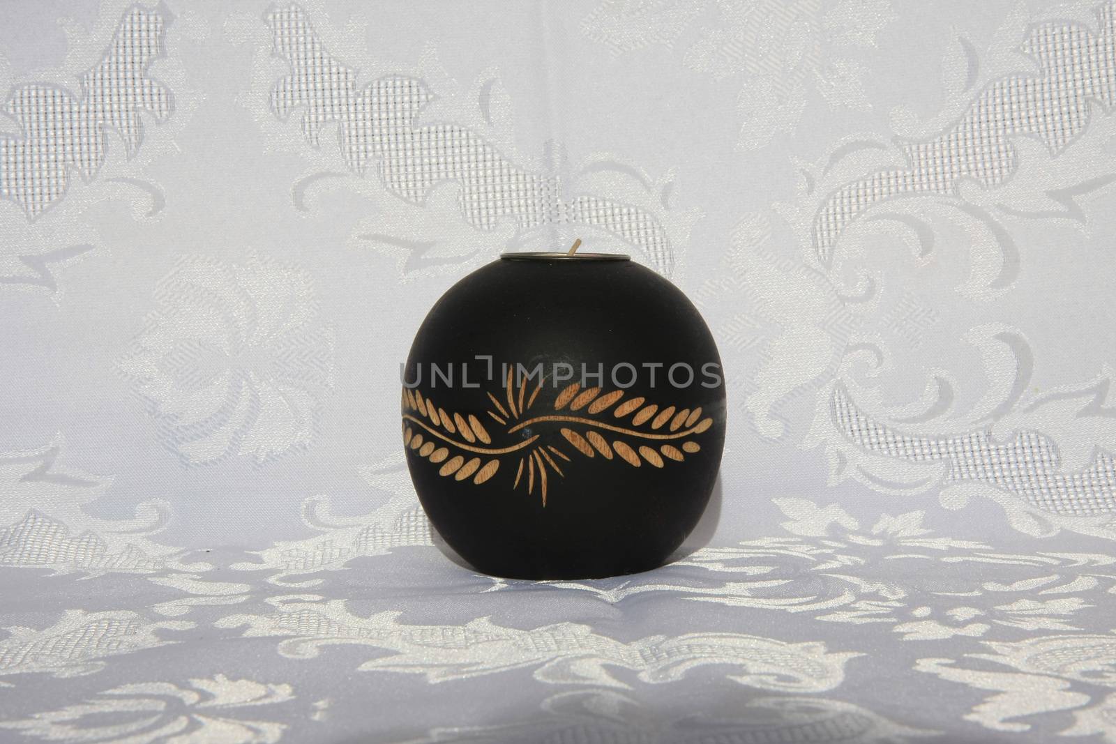 Black wooden decorative candleholder on the table