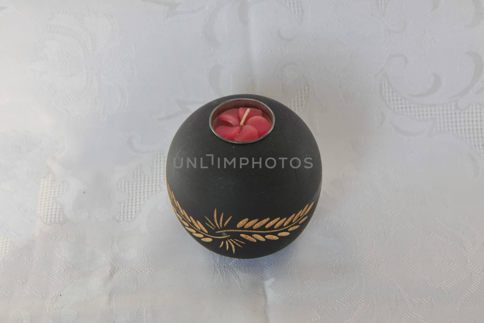 Black wooden decorative candleholder on the table