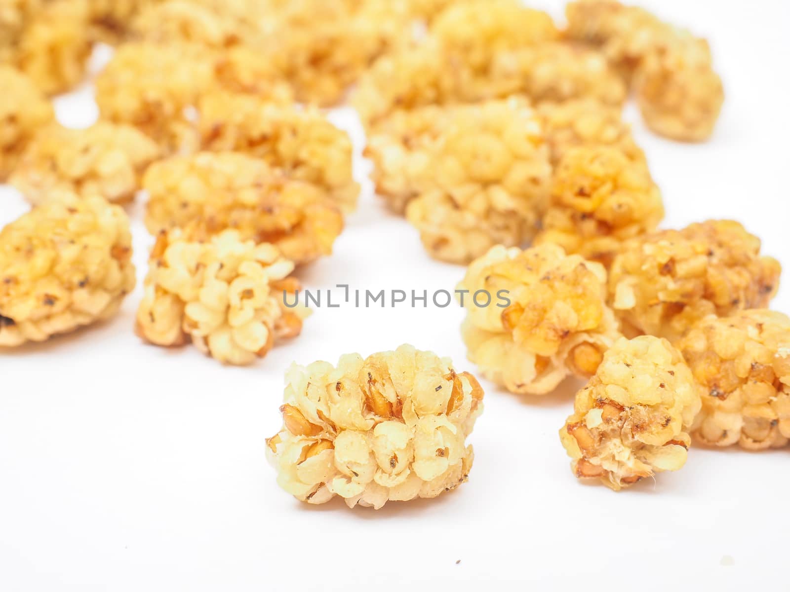 Closeup of dried mulberry fruits isolated towards white background
