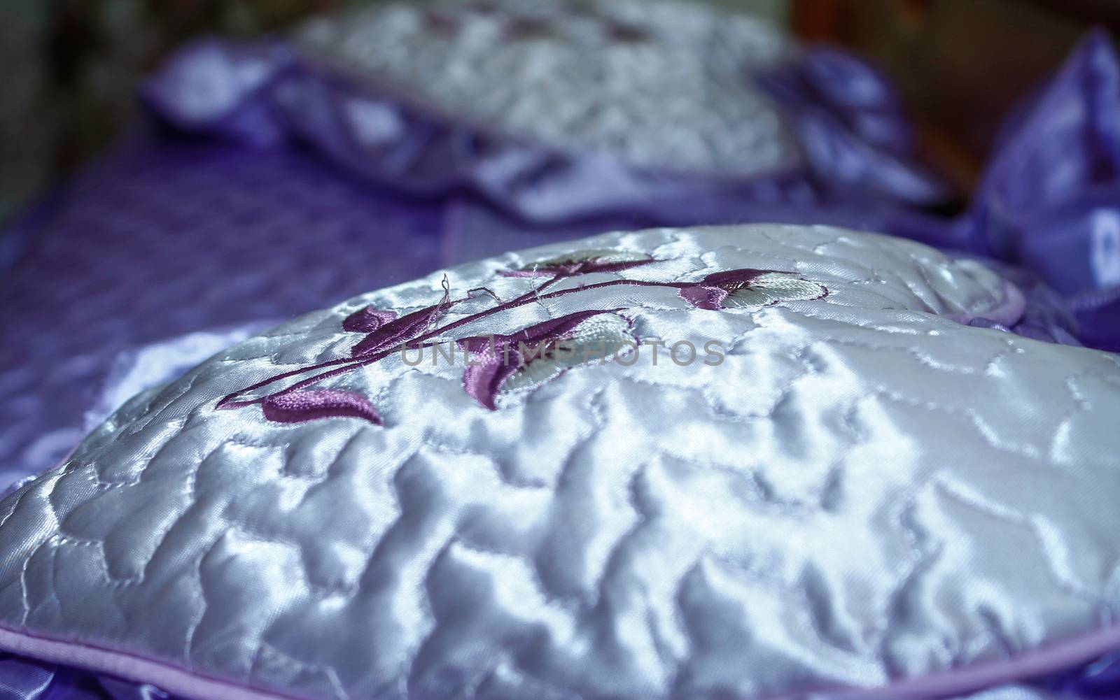decorative wedding pillow on purple covered bed