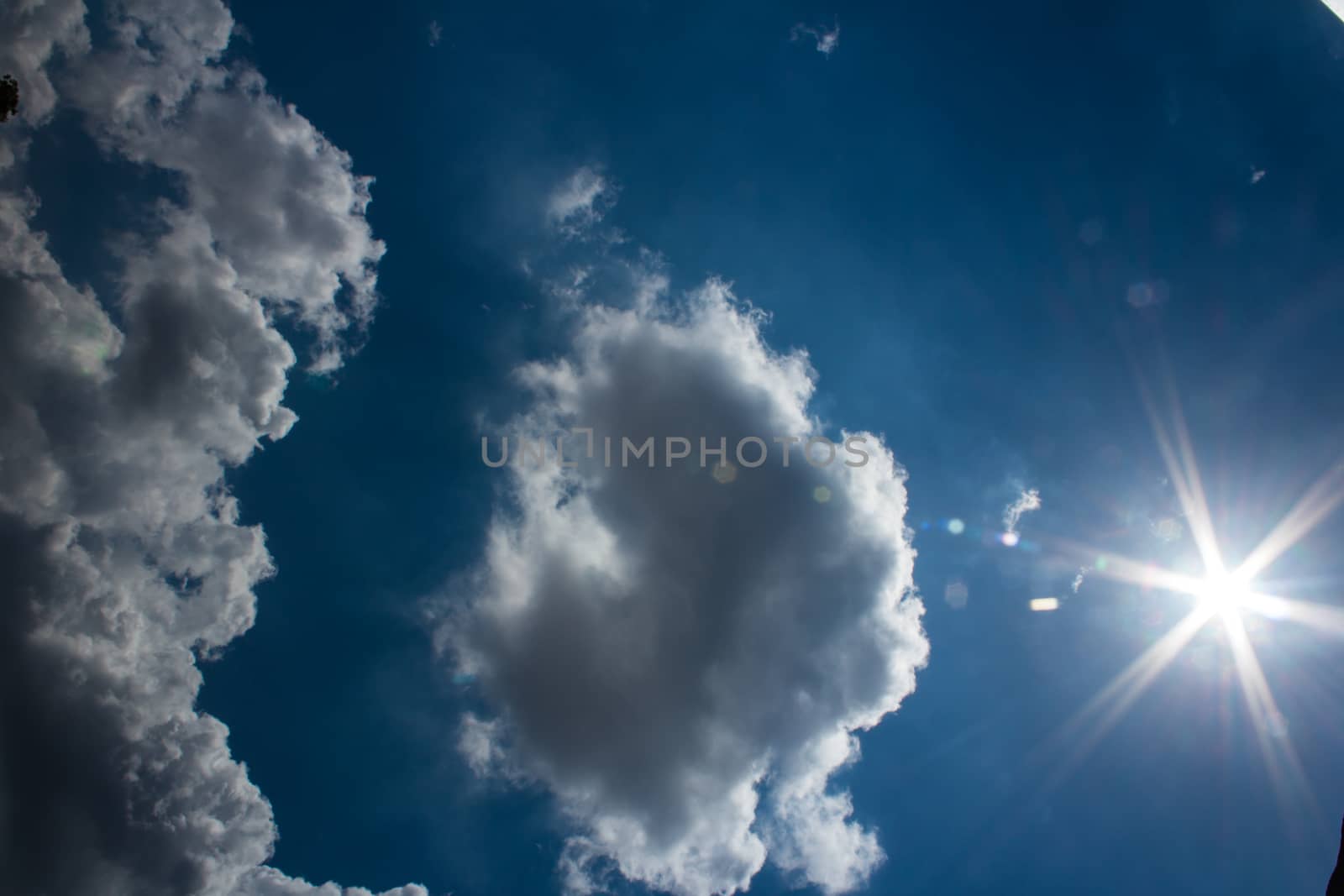 Tropical blue sky with sun and clouds in the afternoon