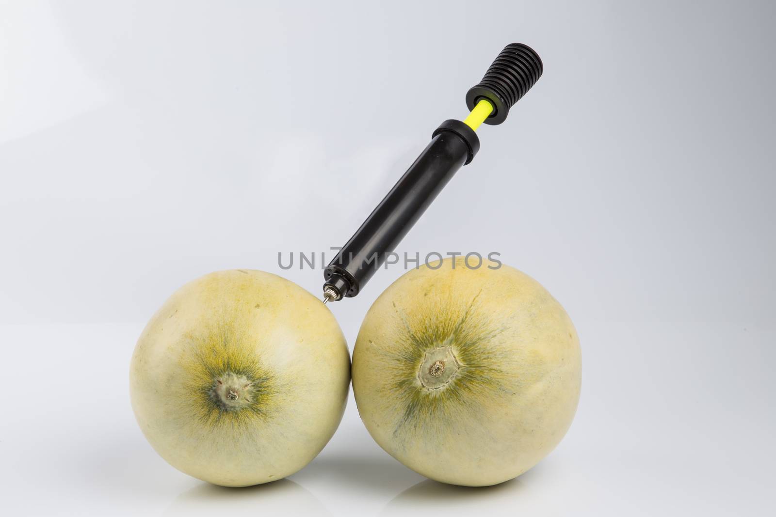 Cosmetic treatment  for Female breasts metaphor: melons air pumped  by bicycle pump meaning cosmetic and health treatment