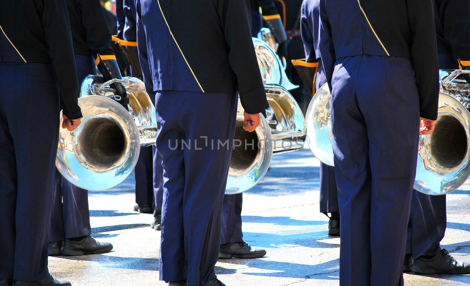 Marching band performing in a parade downtown.