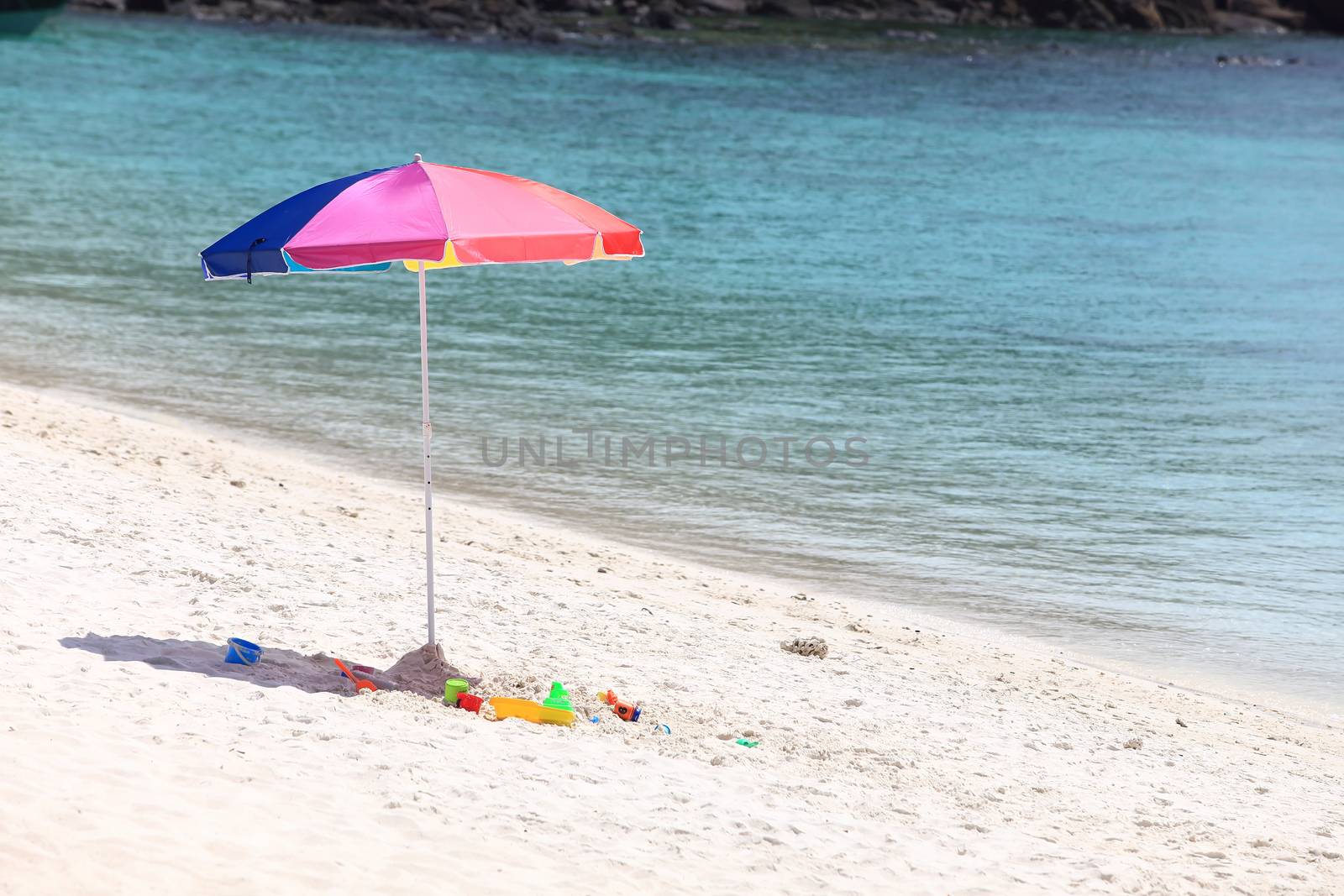 Beach umbrella on a sunny day, sea in background by rufous