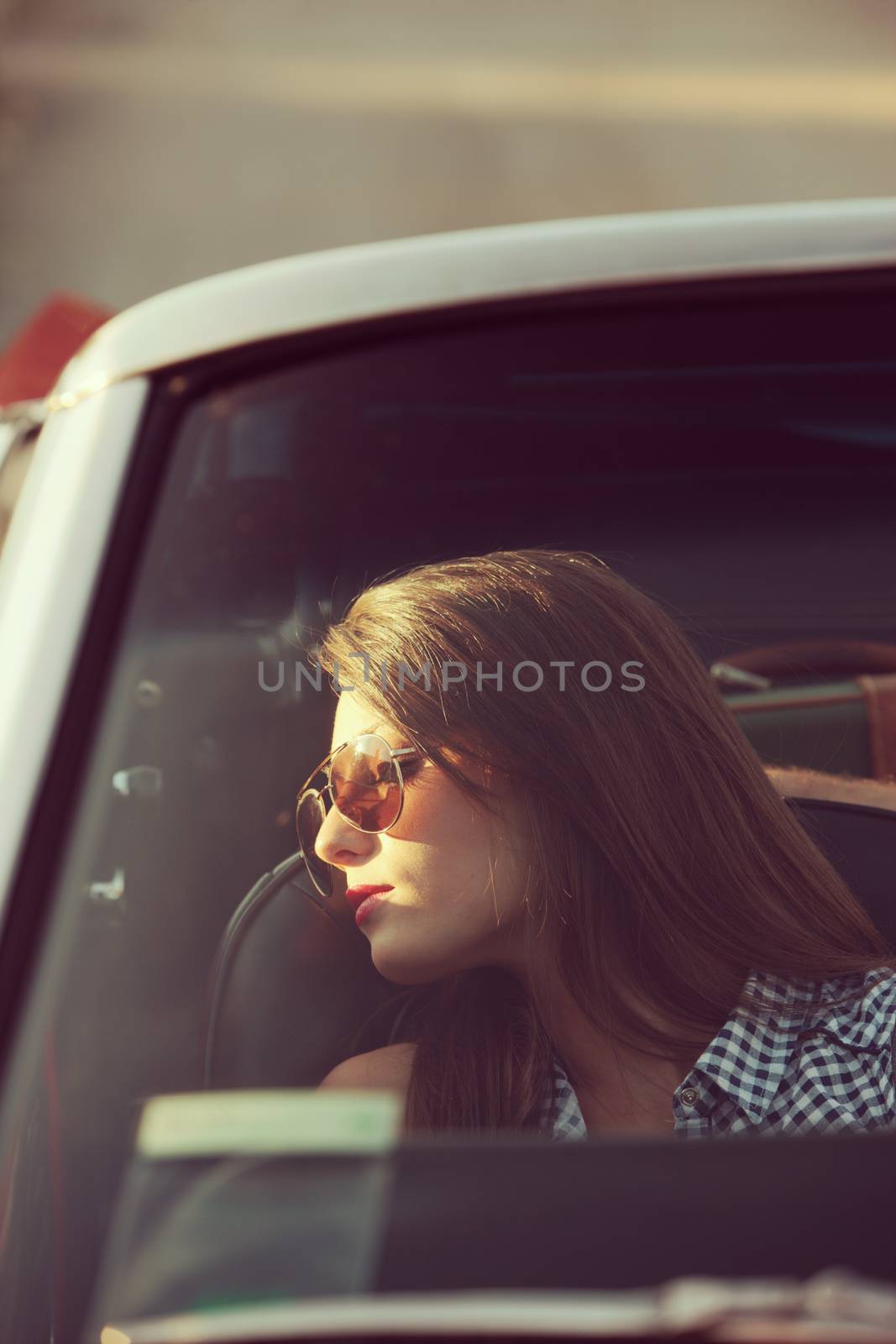 Young beautiful woman sleeping in a convertible car