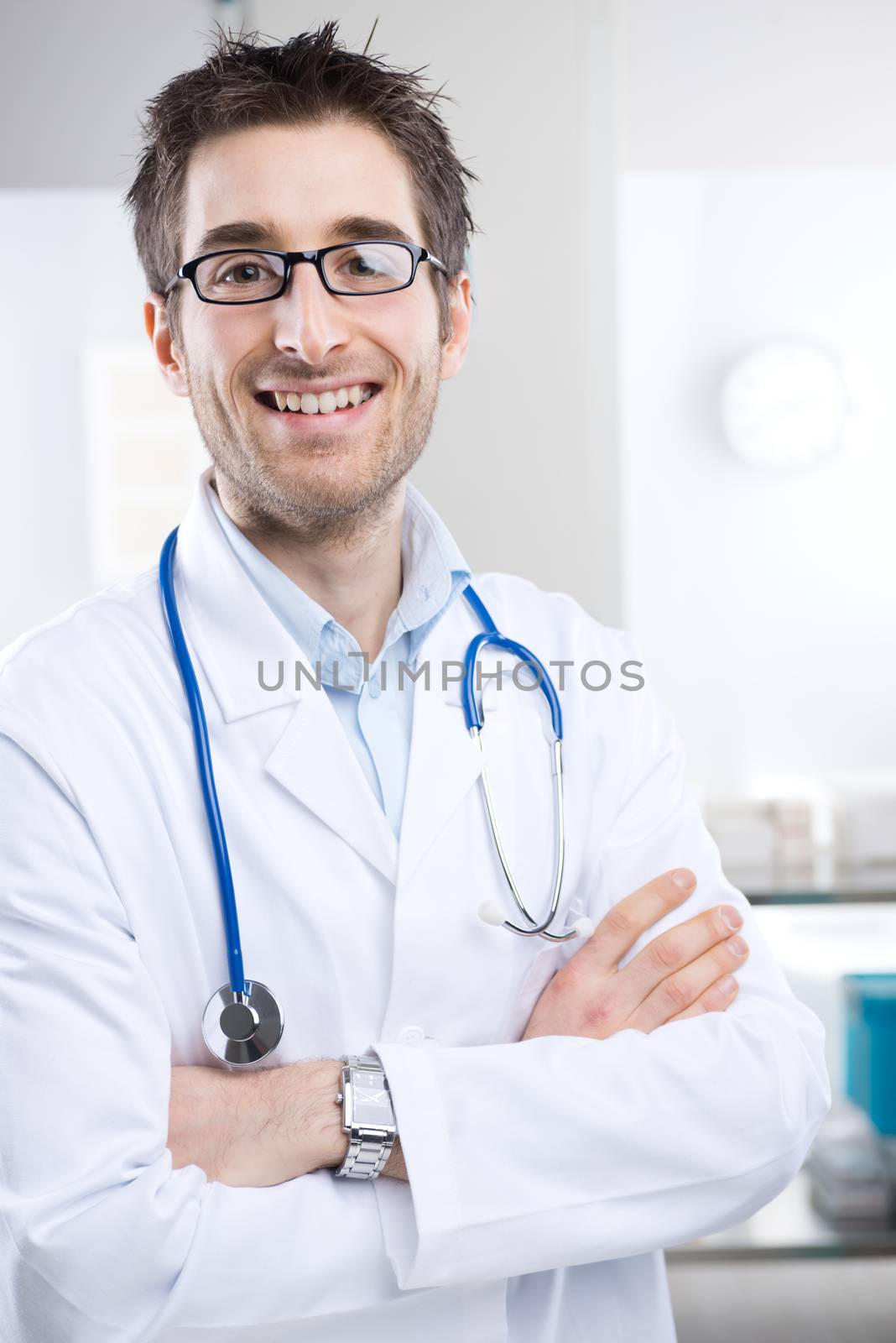Young professional doctor at hospital with crossed arms