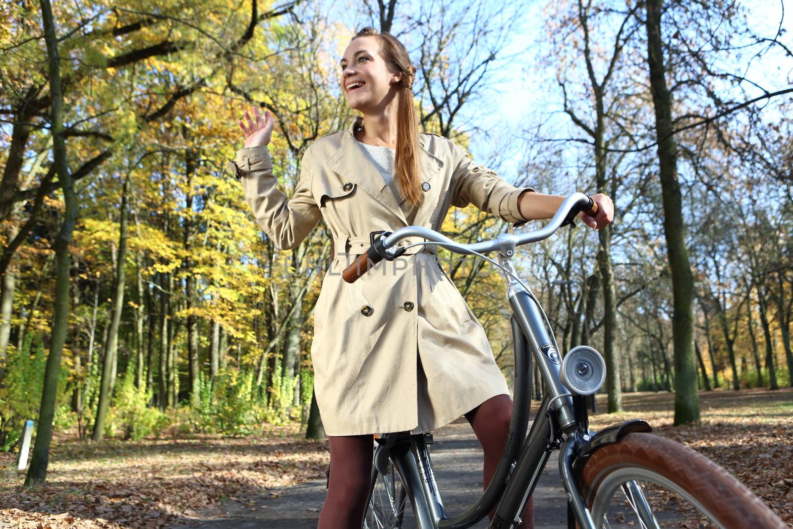 happy woman in autumn bike tour by robert_przybysz