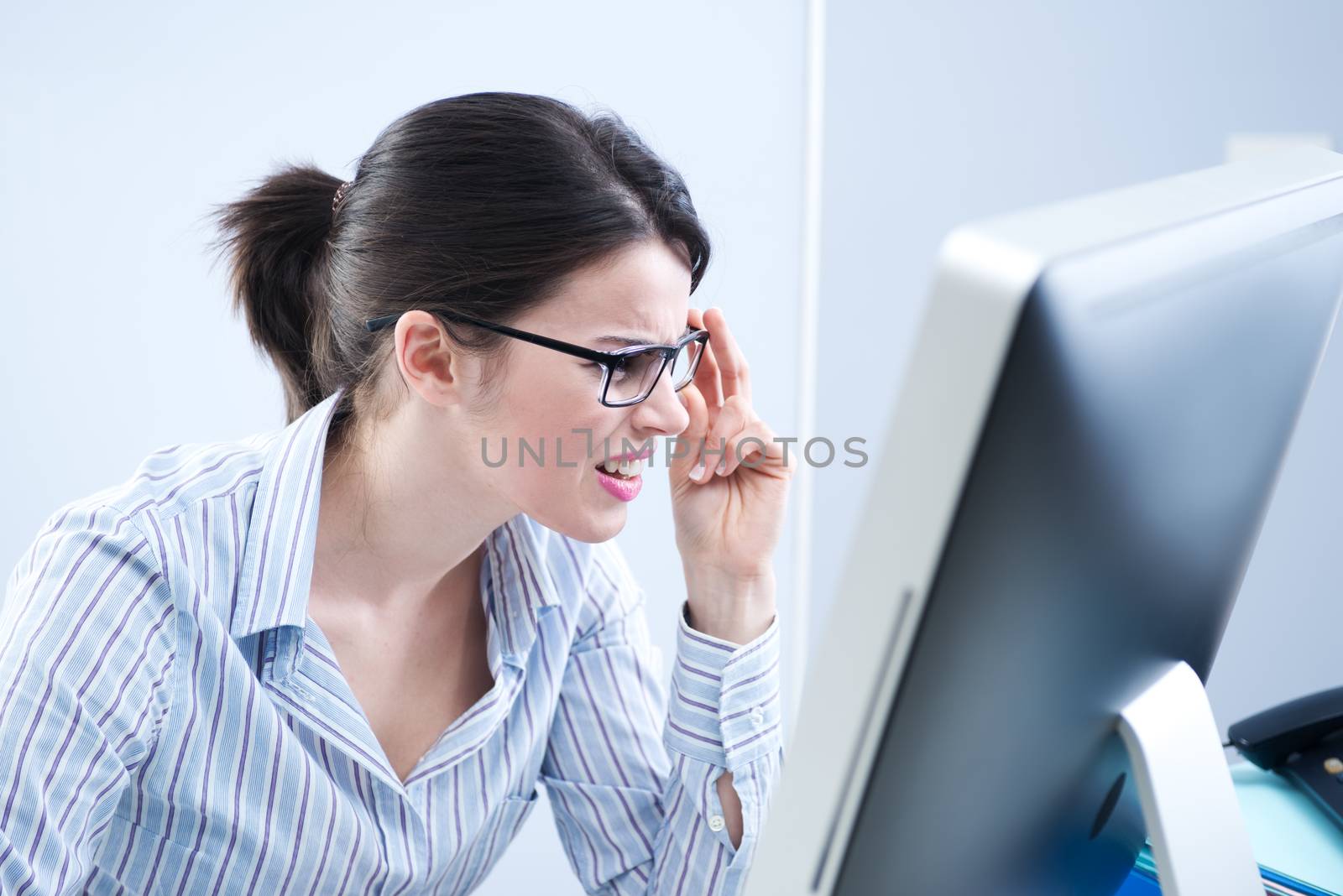 Office worker staring at computer screen by stokkete