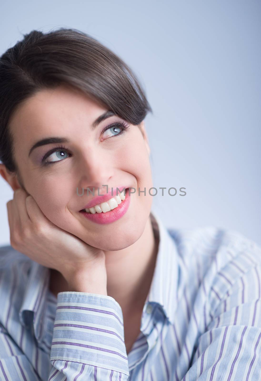 Attractive young woman smiling and looking up.