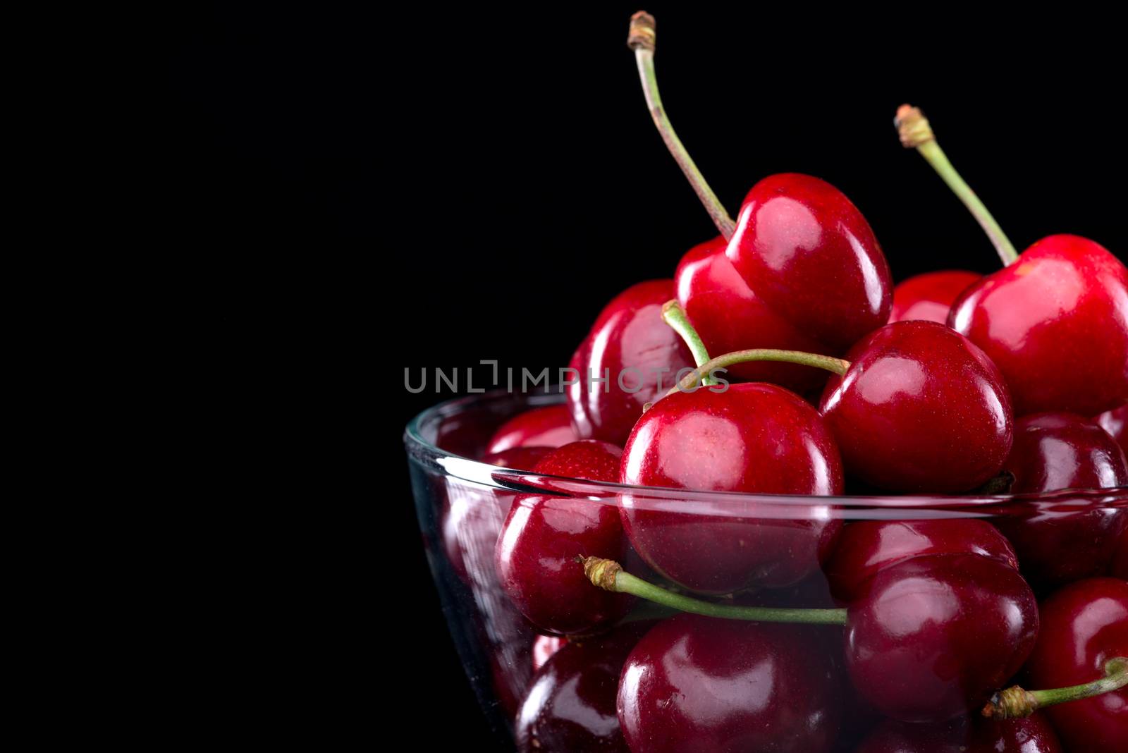 Juicy cherries in a bowl by stokkete