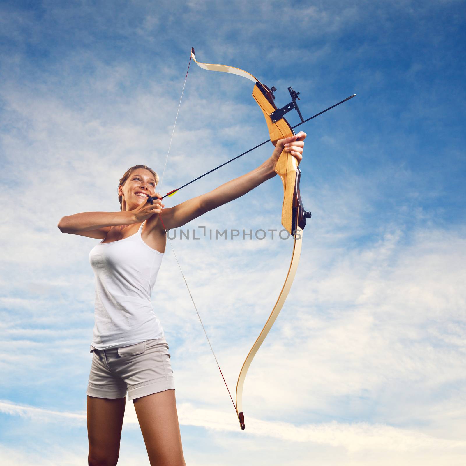 Woman practicing with bow and arrow by stokkete