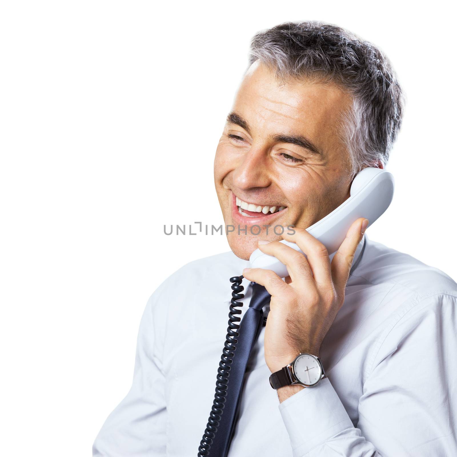 Attractive confident businessman talking on the phone on white background.