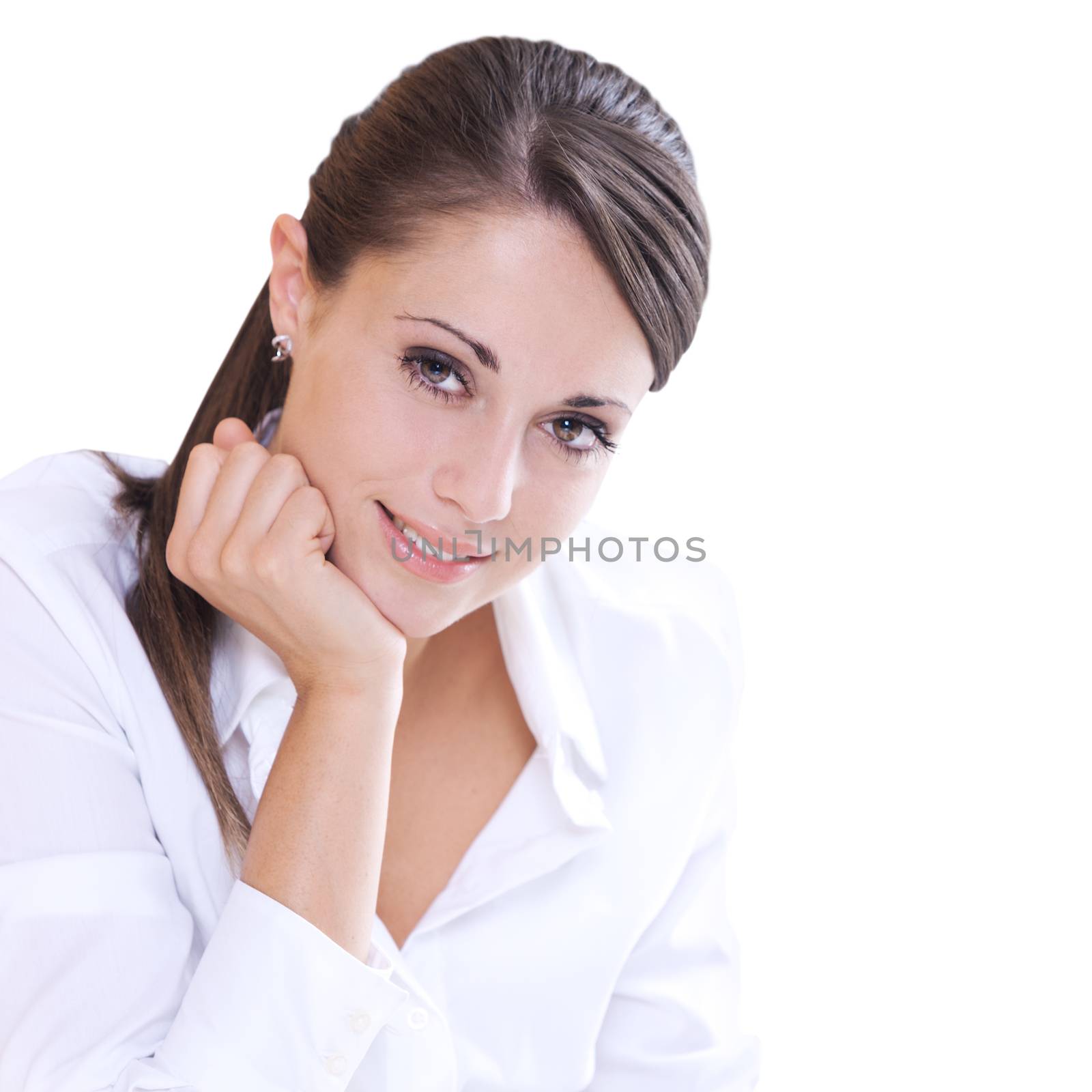 Attractive woman in white shirt with hand on chin looking at camera.