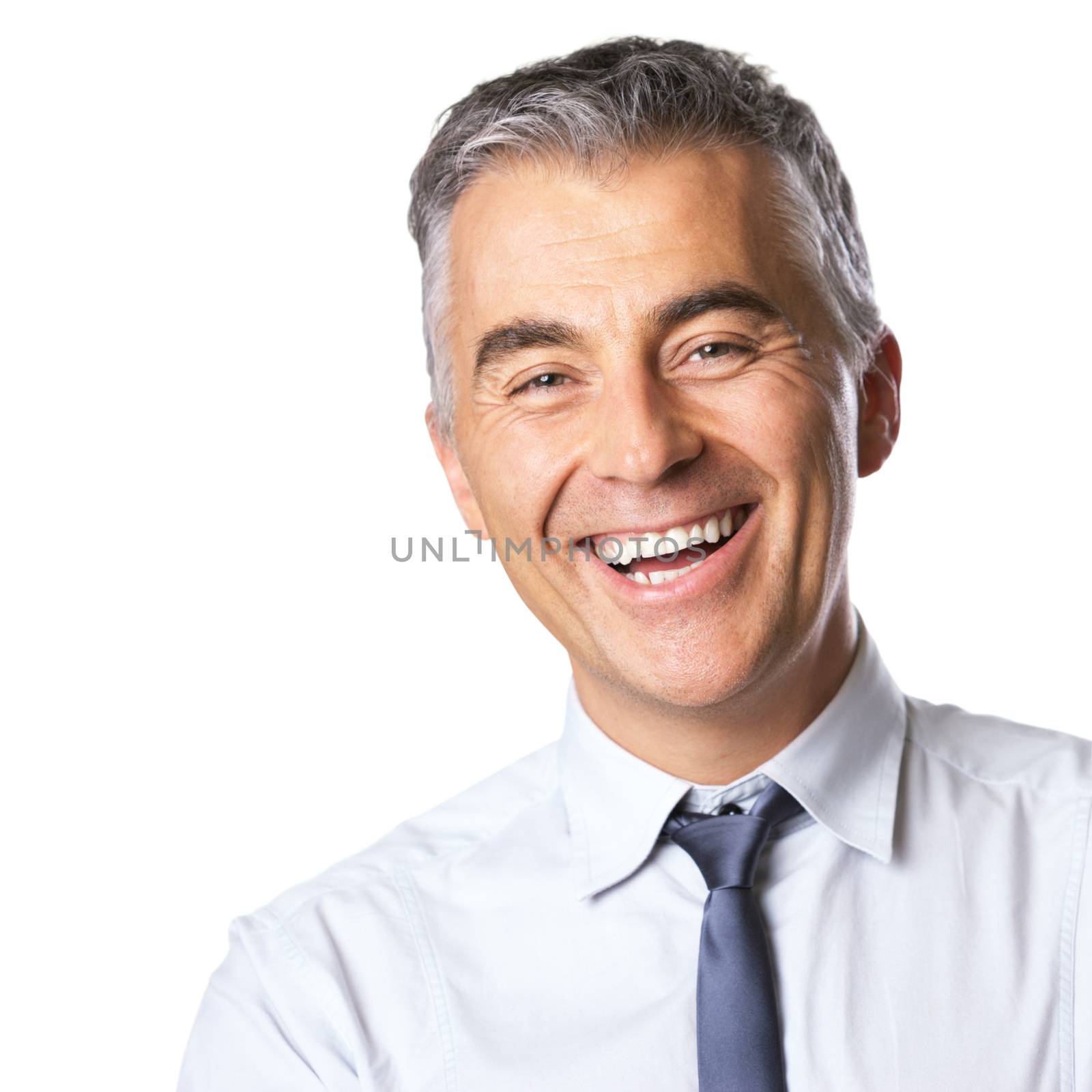 Smiling mature businessman in white shirt and tie looking at camera on white background.