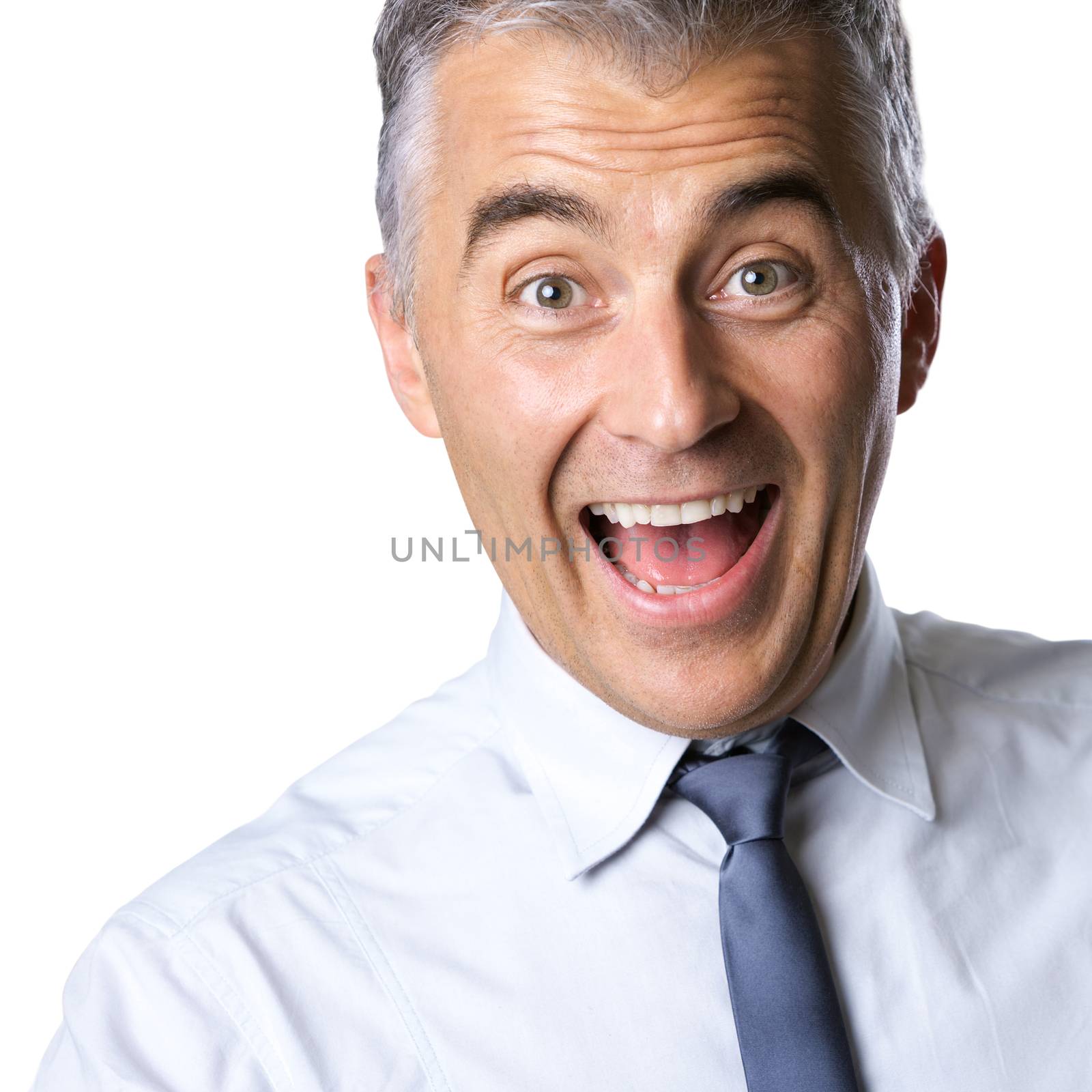 Cheerful excited businessman with mouth open and raised eyebrows on white background.