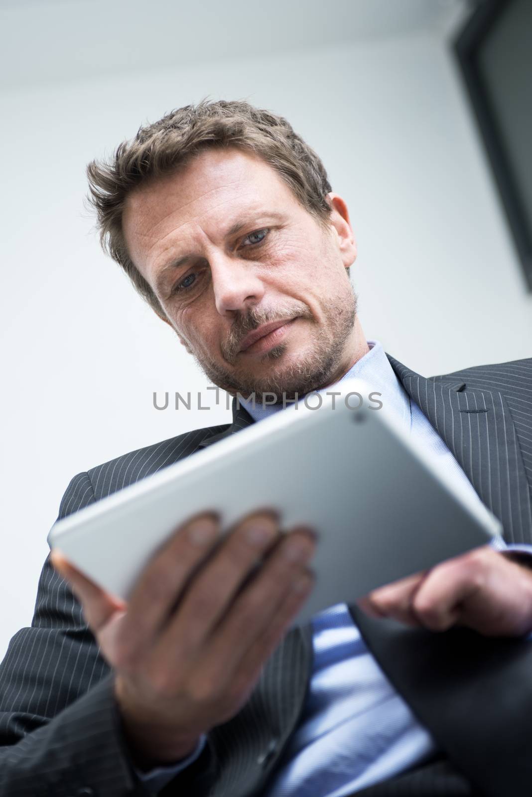 Businessman working with tablet by stokkete