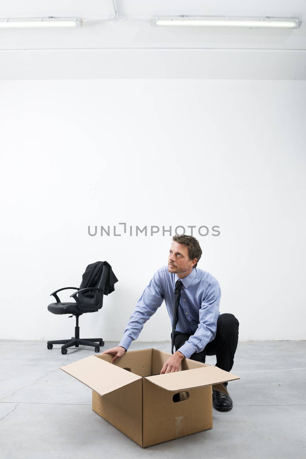 Businessman packing with carbdoard box by stokkete