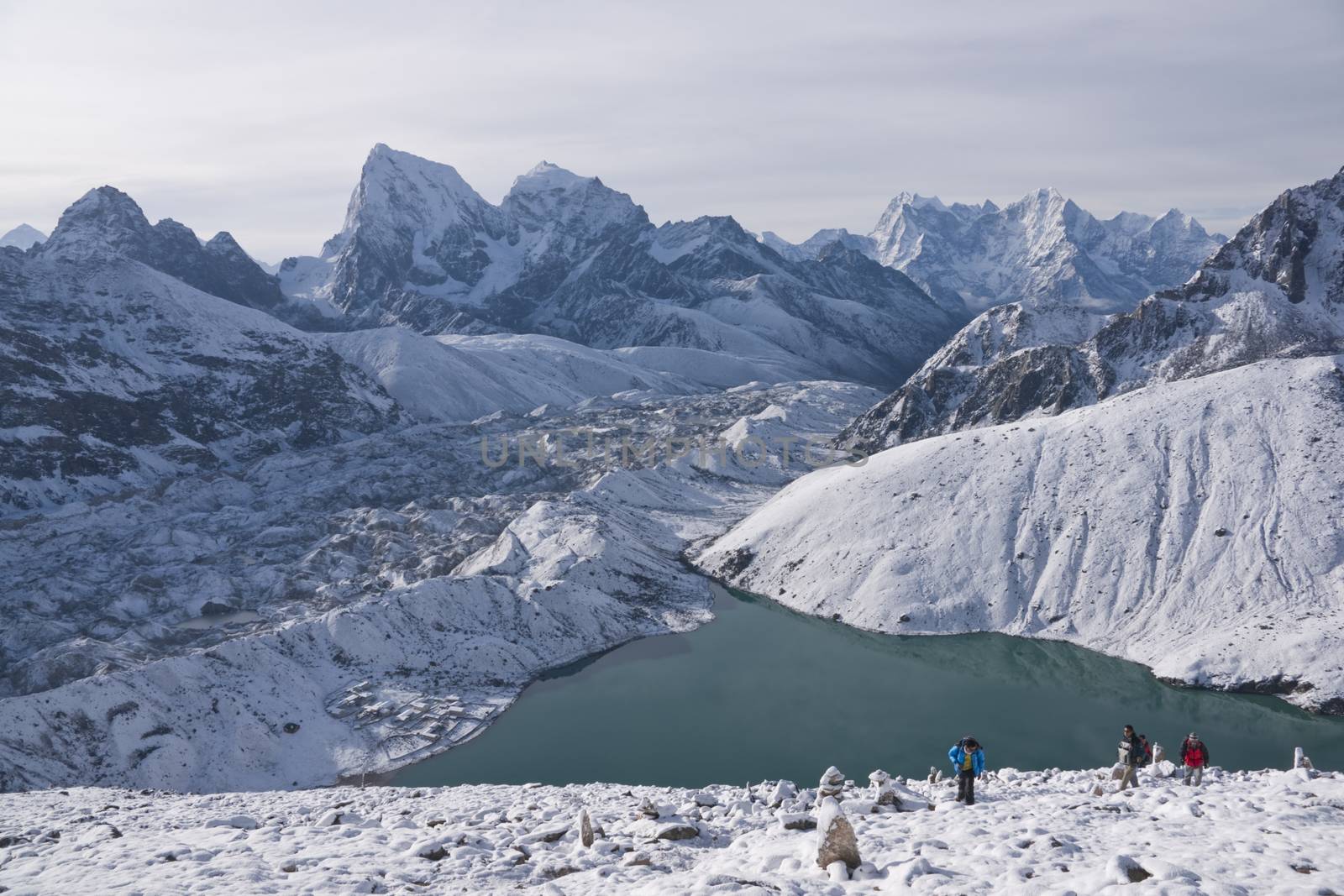 Group of climbing the snow covered mountain side above Gokyo in the Himalaya Mountains of Nepal.