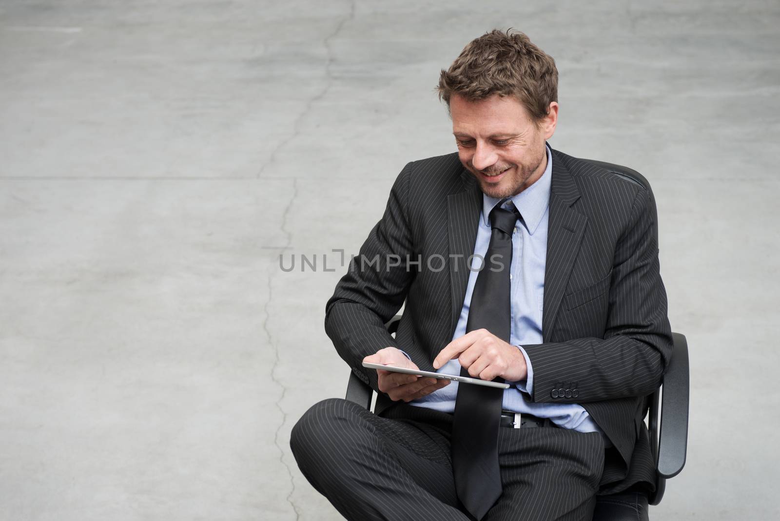Businessman working with tablet by stokkete