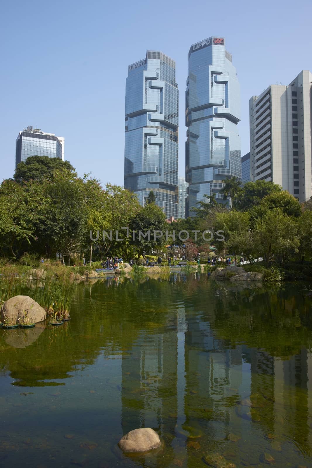 Modern architecture of the financial district towers above a city park in Hong Kong, China