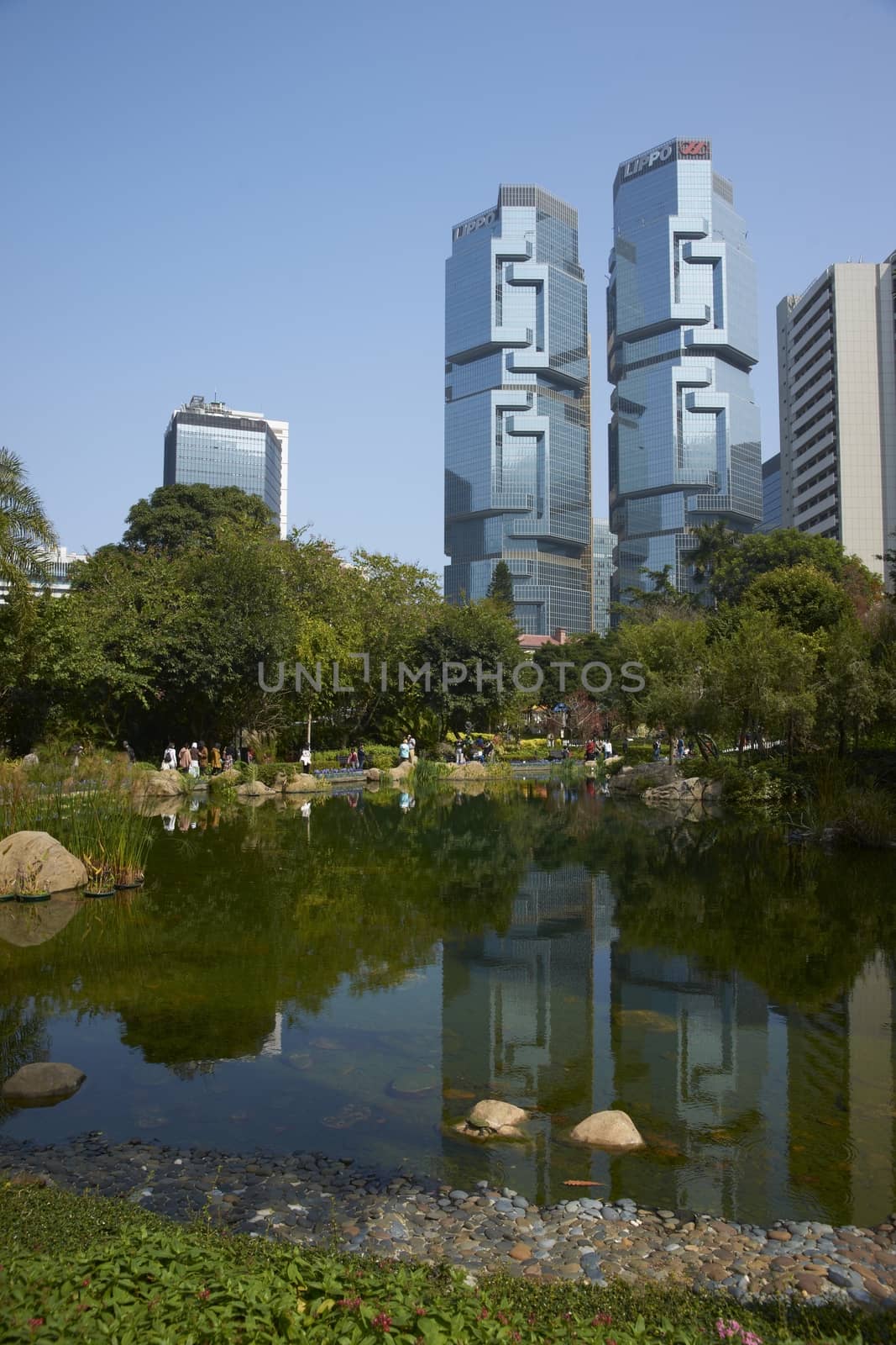 Modern architecture of the financial district towers above a city park in Hong Kong, China