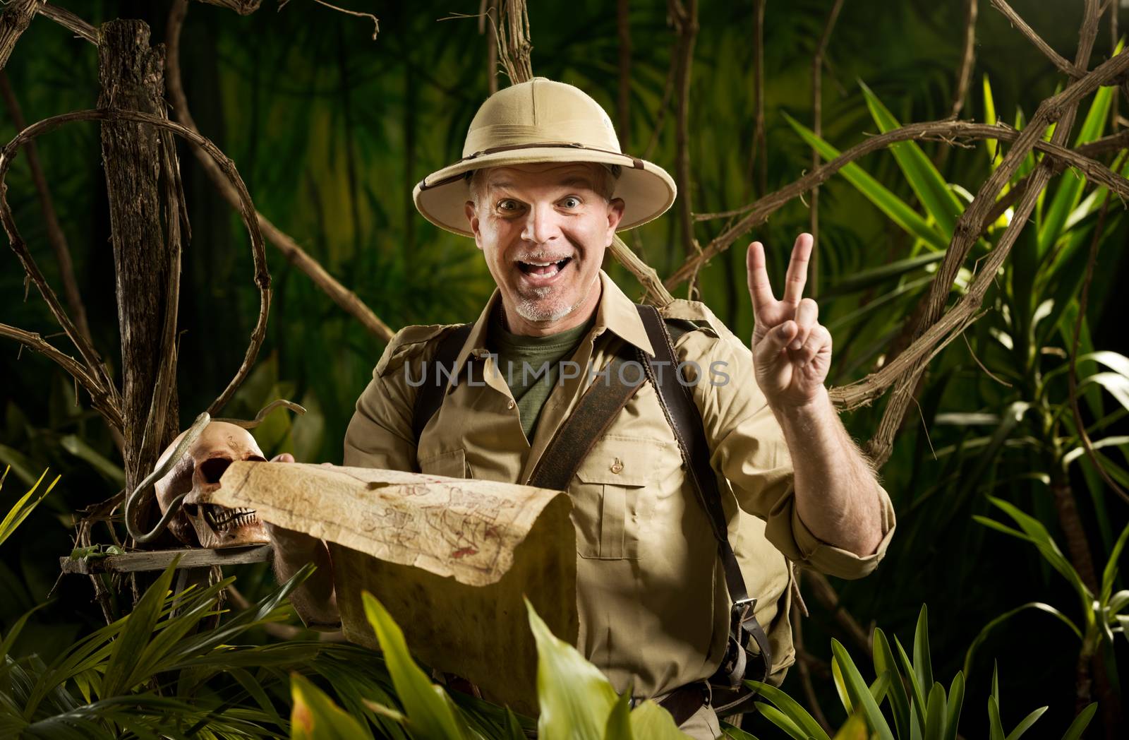 Successful pioneer in the jungle finding right direction on map.