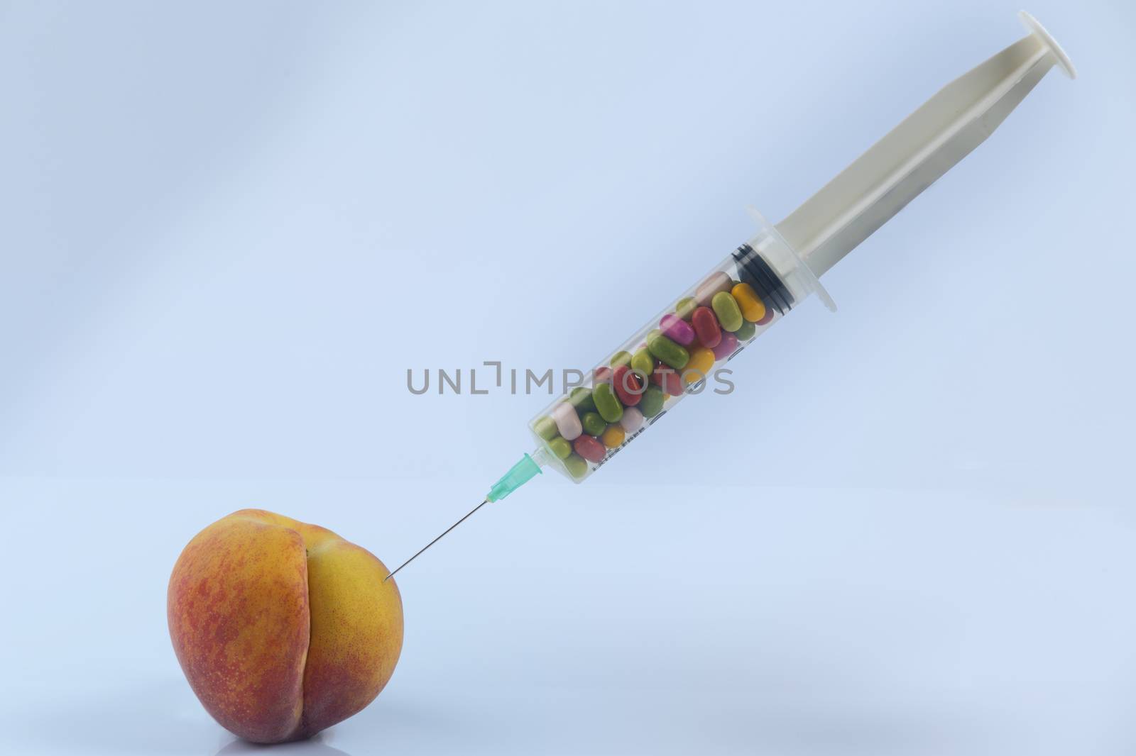 Female menopause and sexual disease metaphor: peach and syringe with meaning cosmetic and health treatment for female ageing