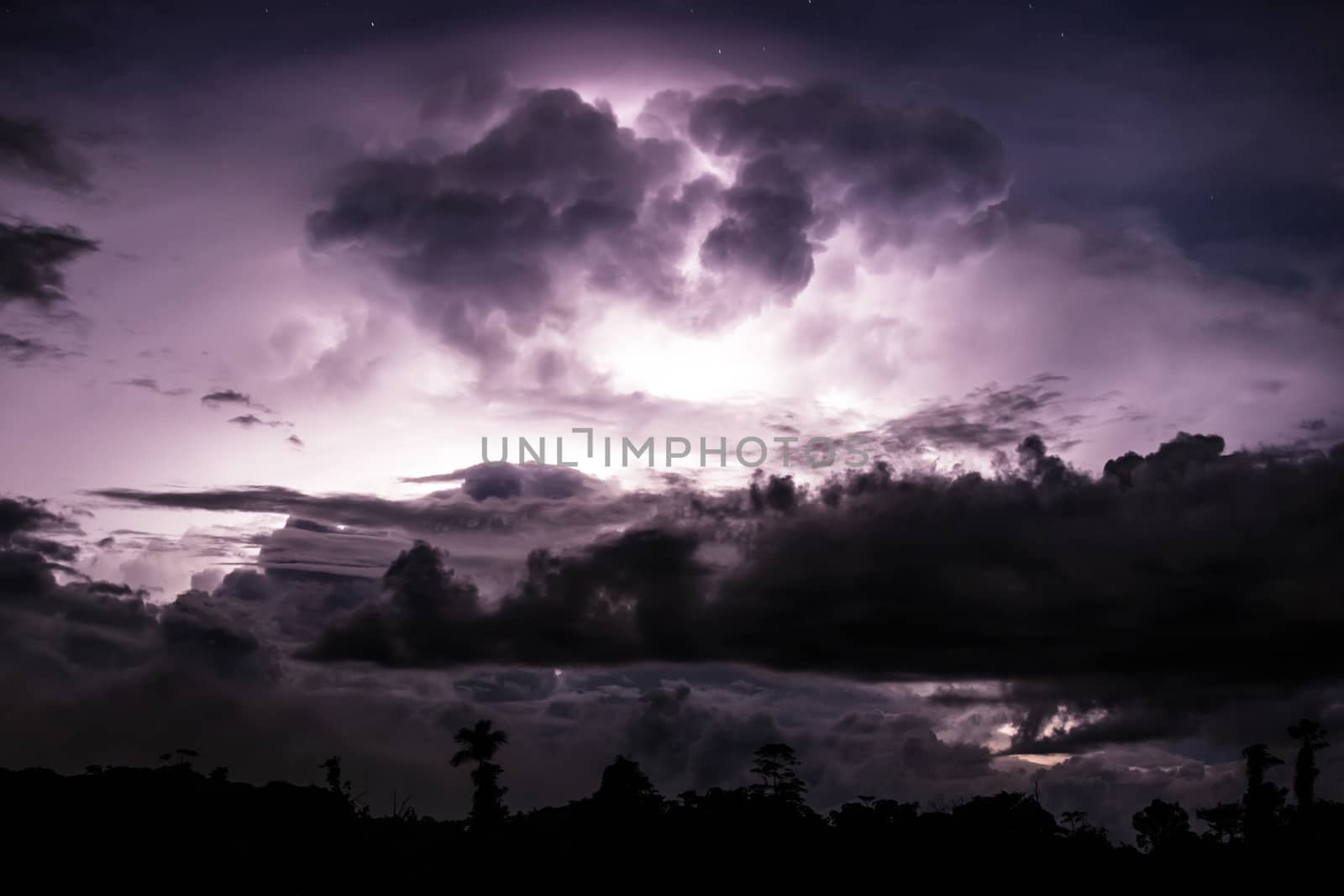 Thundercloud illuminated by lightning by juhku