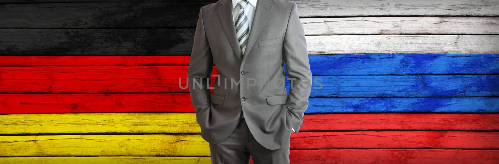 Businessman in a suit. Germany and Russian flags as background. Concept of business