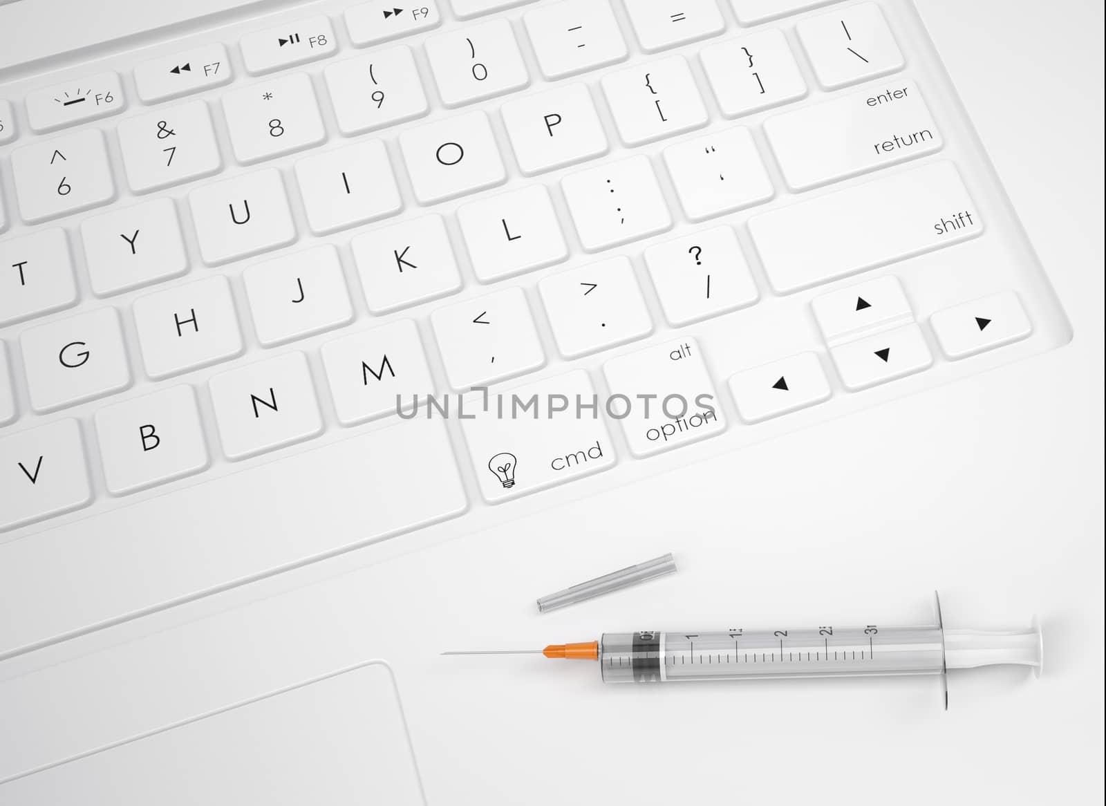 Syringe on the keyboard. View from above