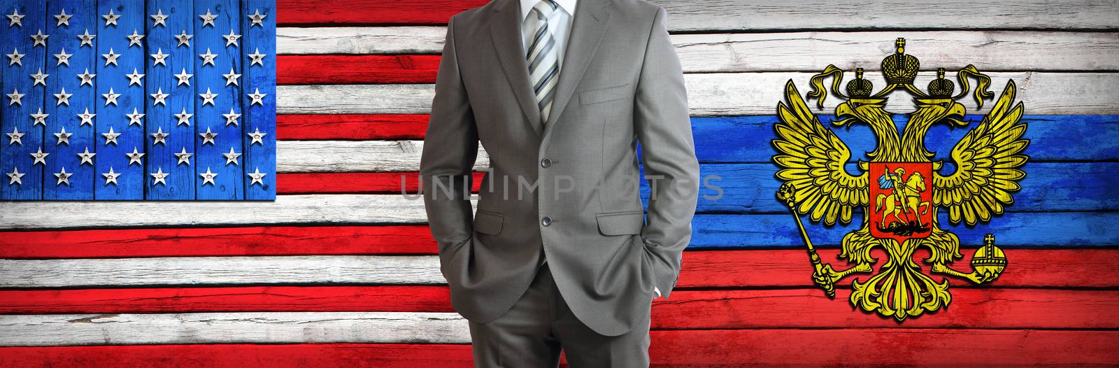 Businessman in a suit. USA and Russian flags as background. Concept of business