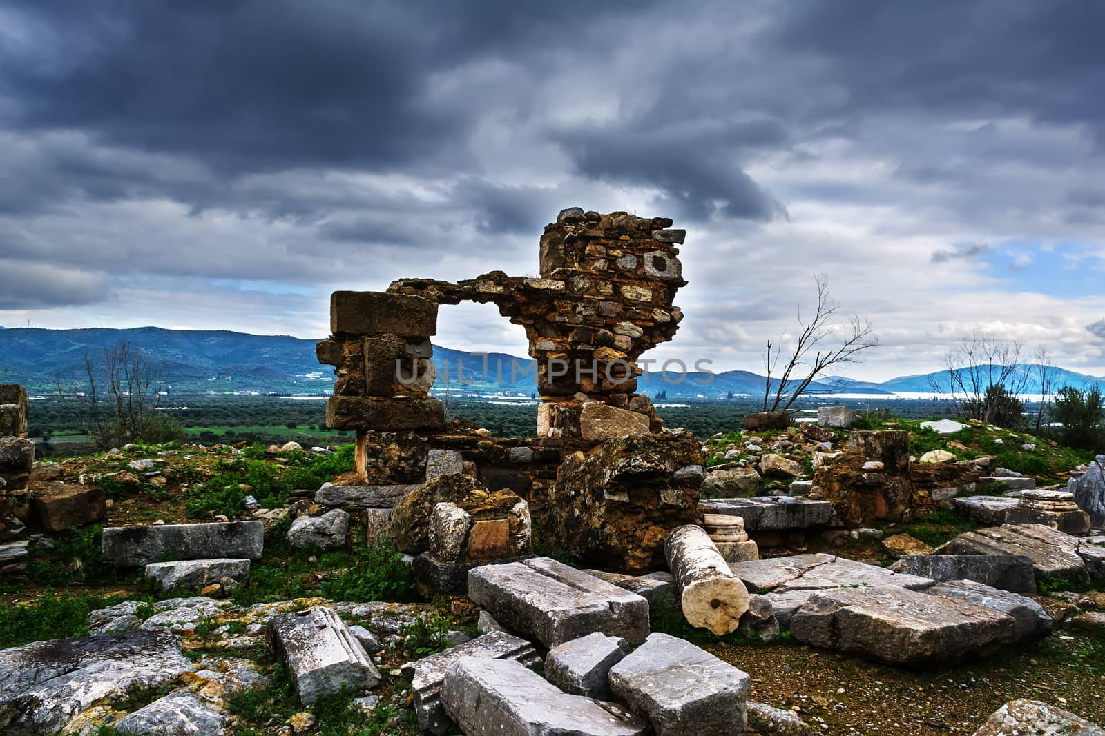 Pillar ruins at Ancient Troizina at dramatic sky, Peloponnese, Greece