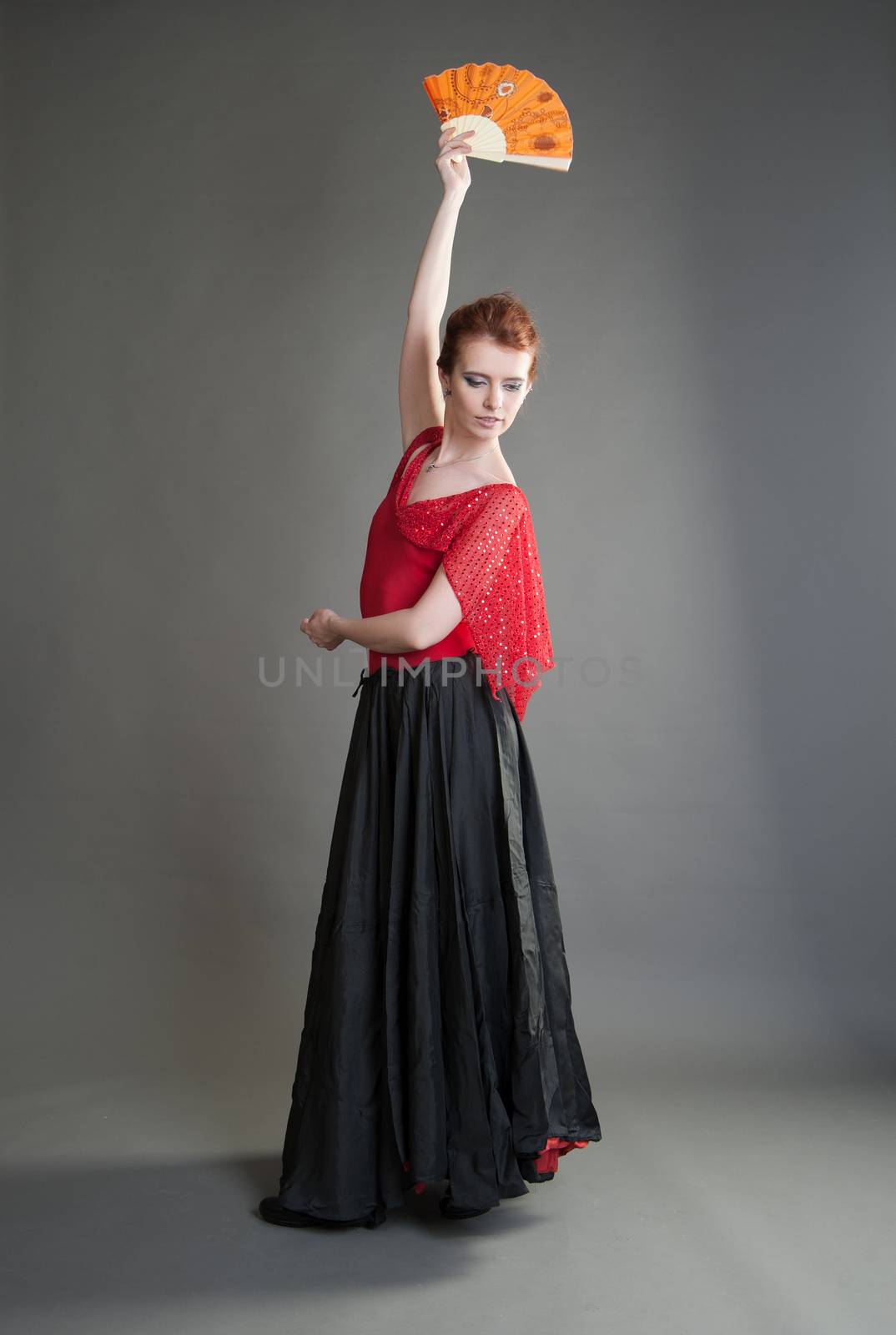 girl with a fan black skirt dancing flamenco