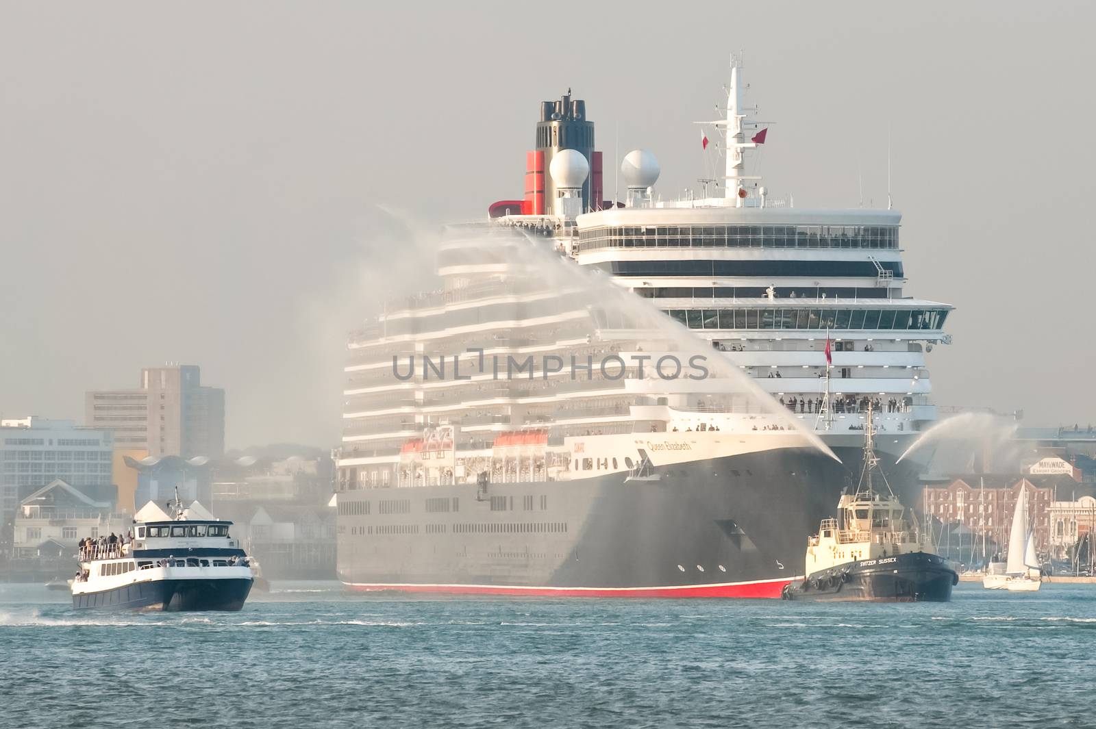 Southampton, UK - October 12, 2010: A hazy sunset departure from port for the Queen Elizabeth cruise liner on her maiden voyage from Southampton, UK
