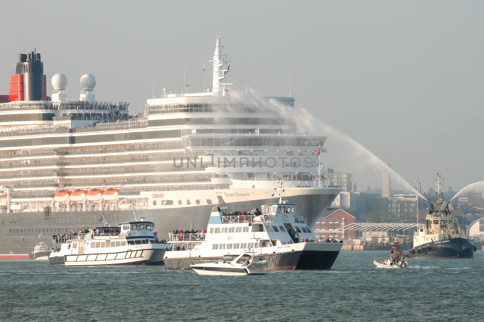 Southampton, UK - October 12, 2010: Flotilla escort of small boats for the Queen Elizabeth ocean cruise liner on her maiden voyage from Southampton, UK